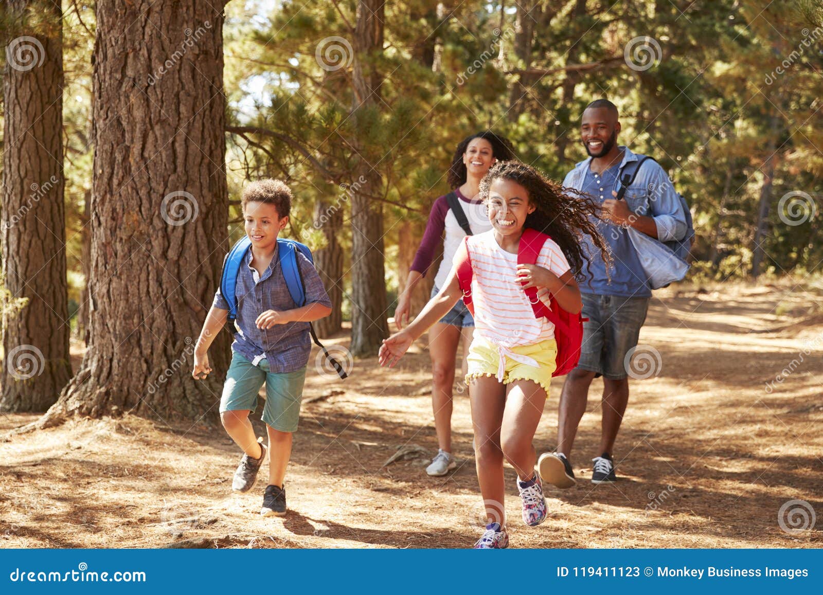 children running ahead of parents on family hiking adventure