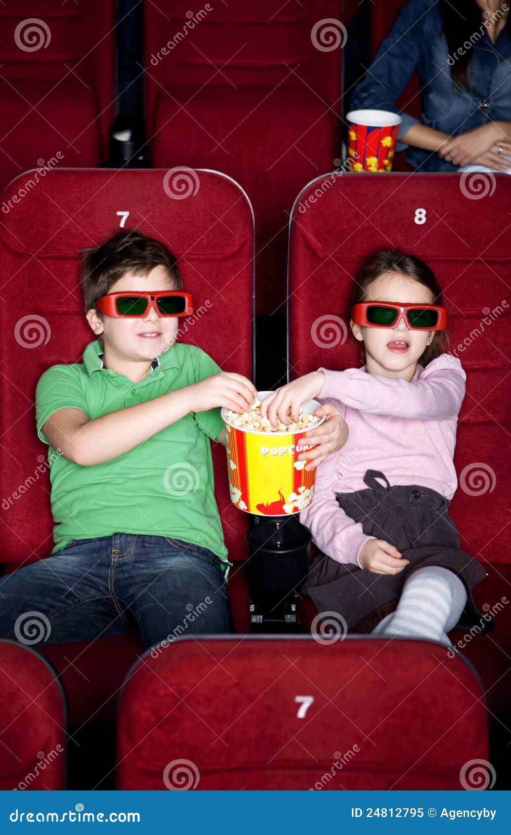 Children sharing popcorn stock image. Image of males 24812795