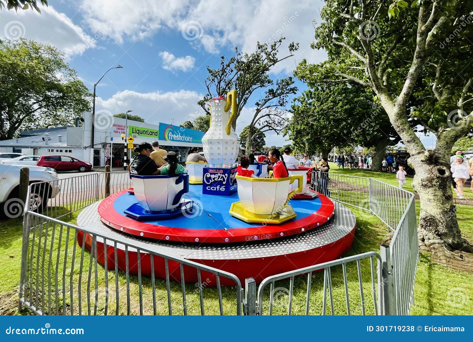 Children Sitting Happily in Rotating Coffee Cups. Editorial Stock Photo