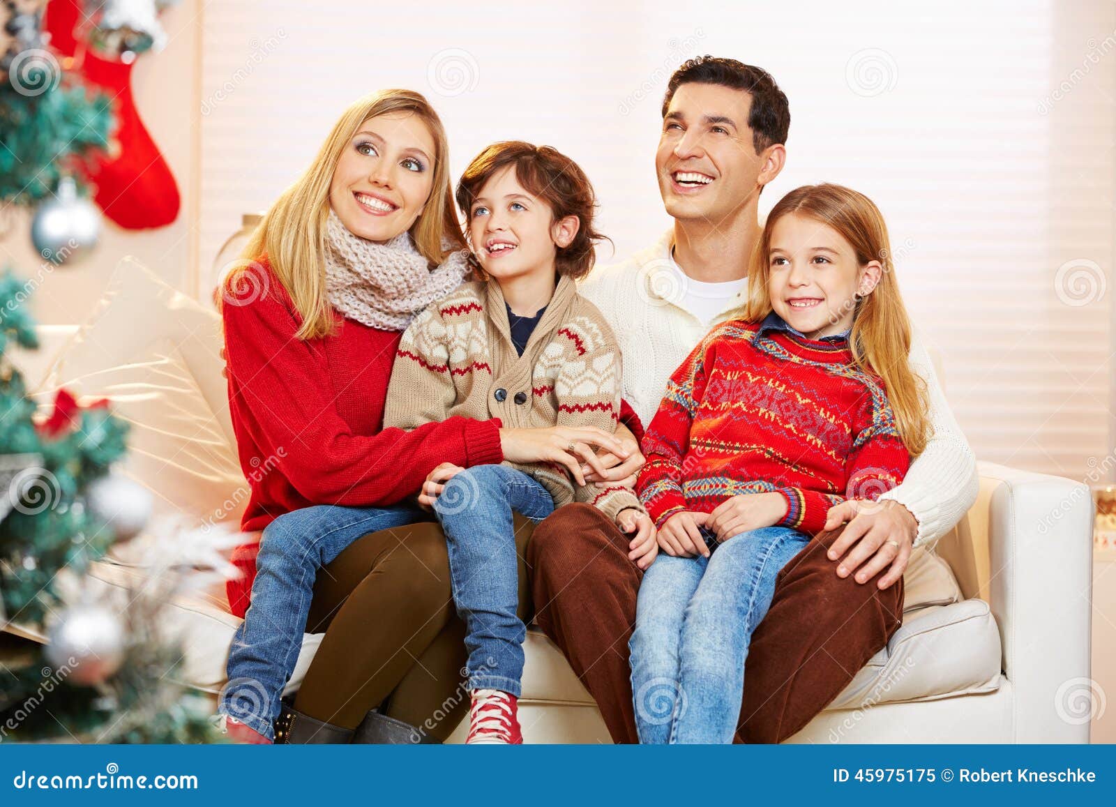 Children Sitting on Lap of Their Parents at Christmas Stock Image