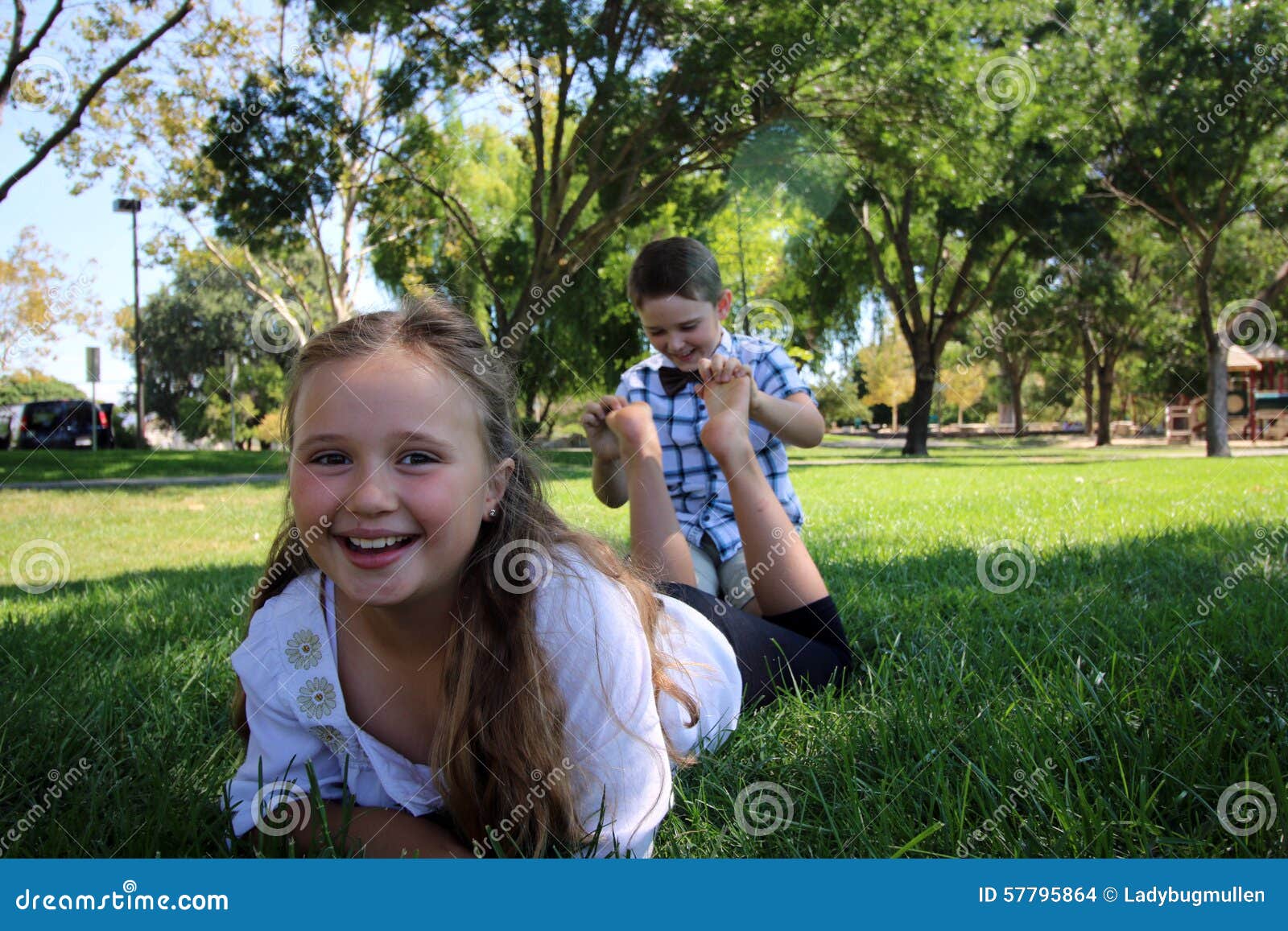 children with their feet in the air/ being tickled