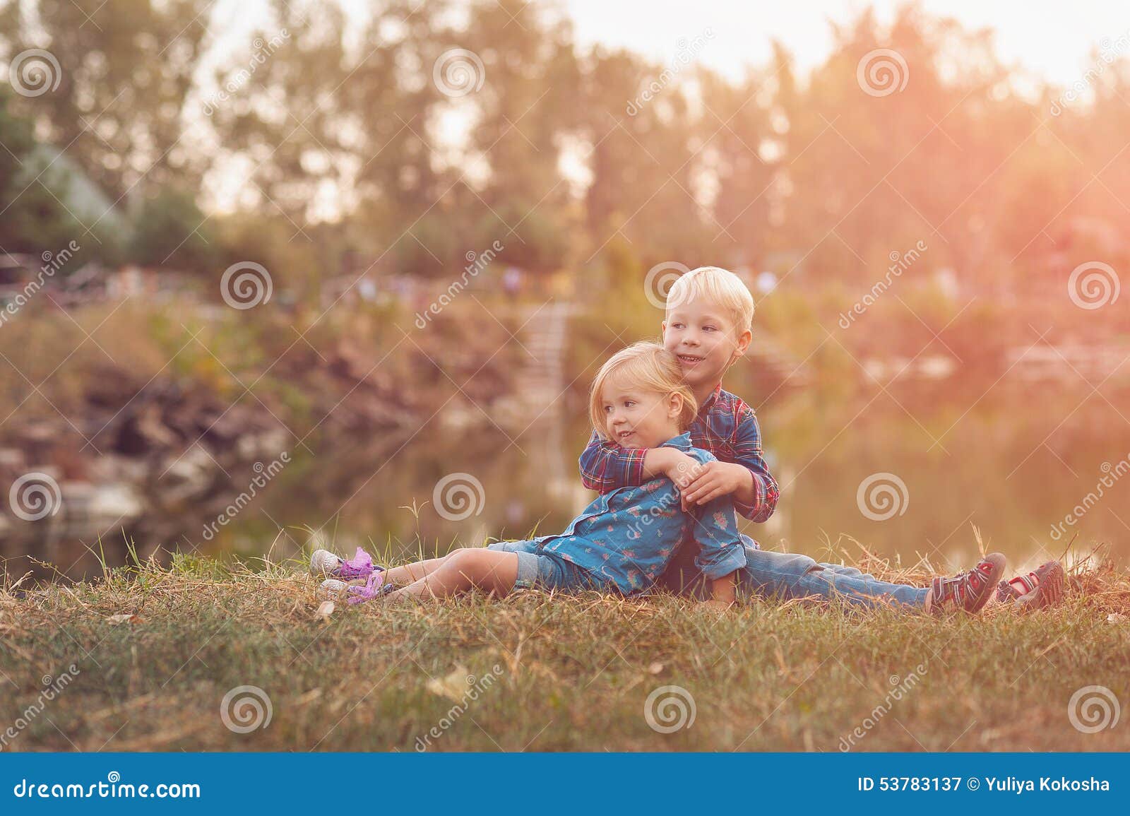 Children watch the sunset. Brother and sister looking at the sunset