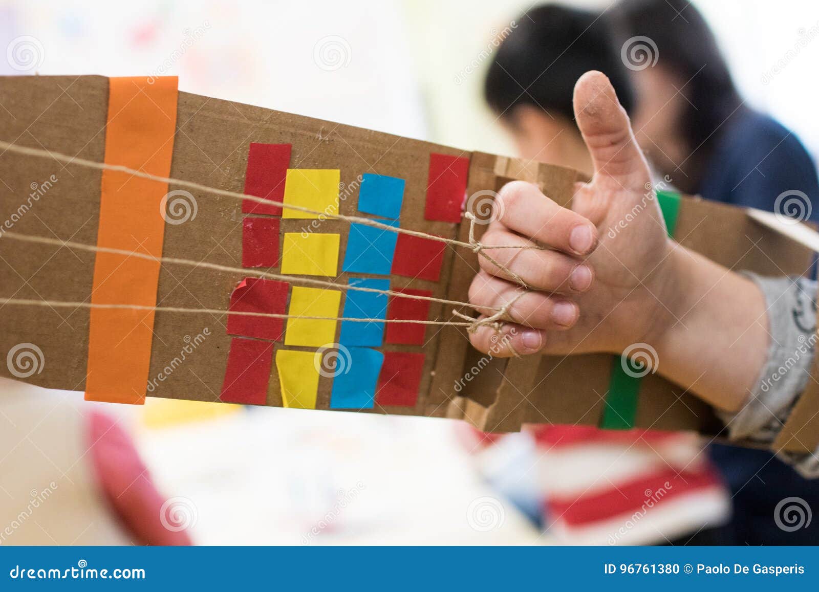 Children is Wearing a Robotic Arm Made with Cardboard. Stock Photo - of