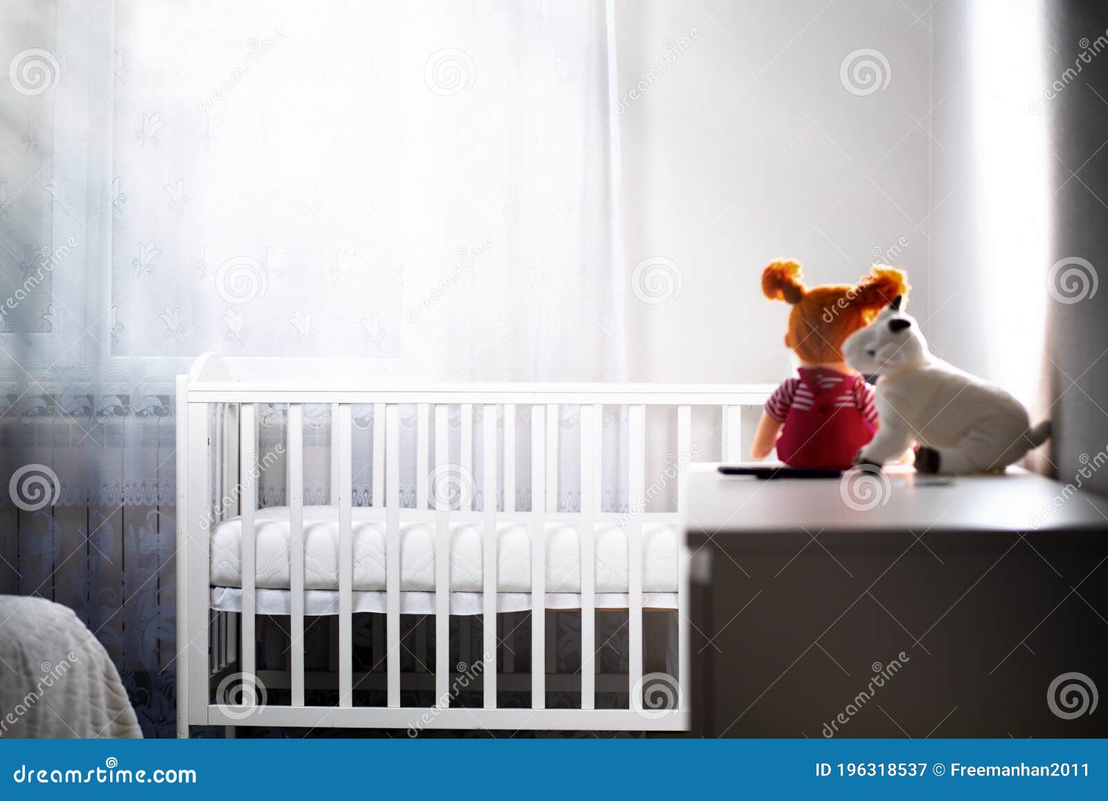 children& x27;s room with an empty cradle and toys on the dresser. copy space.concept of abortion and female infertility