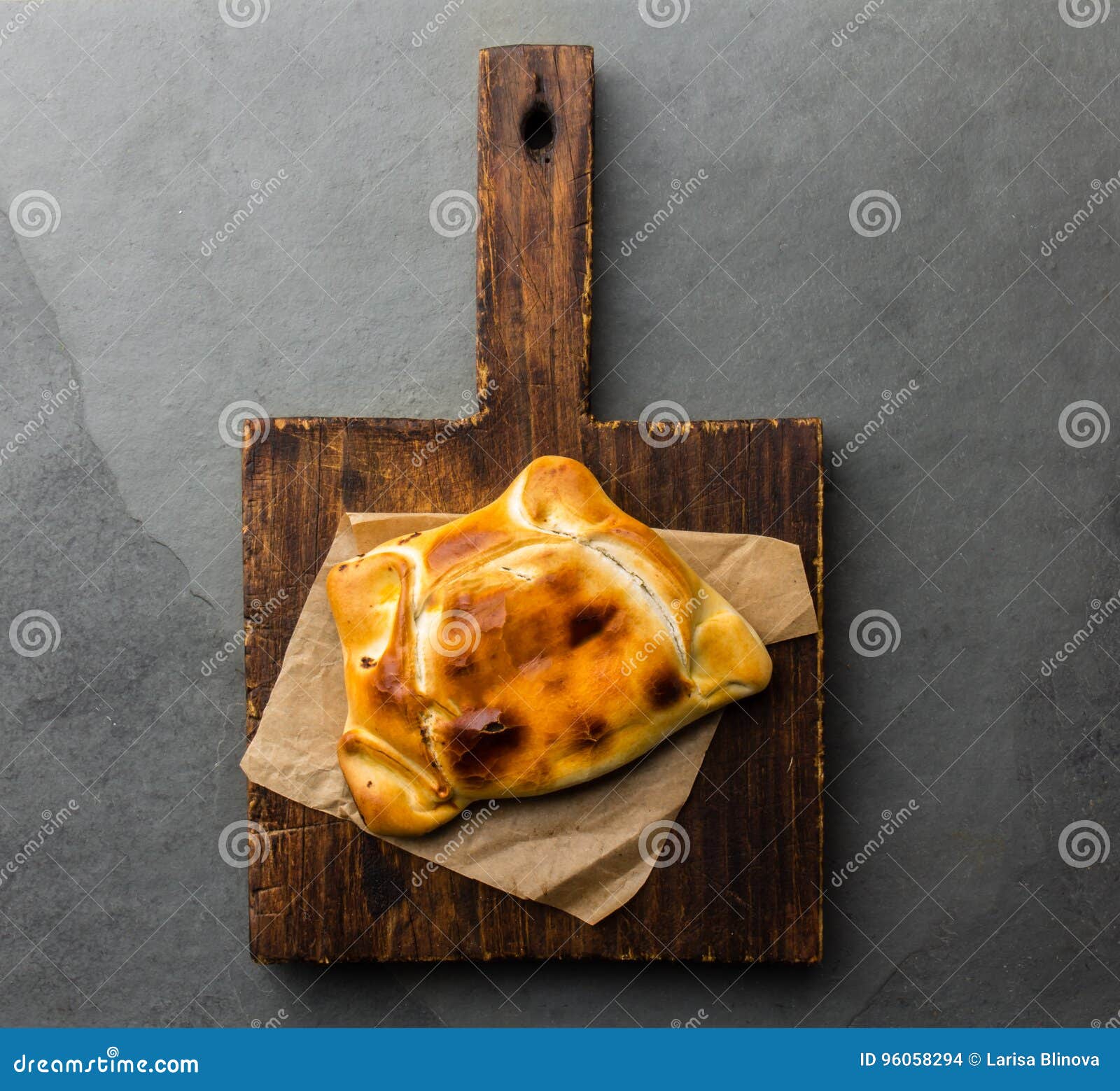 chilean empanada de pino on wooden board