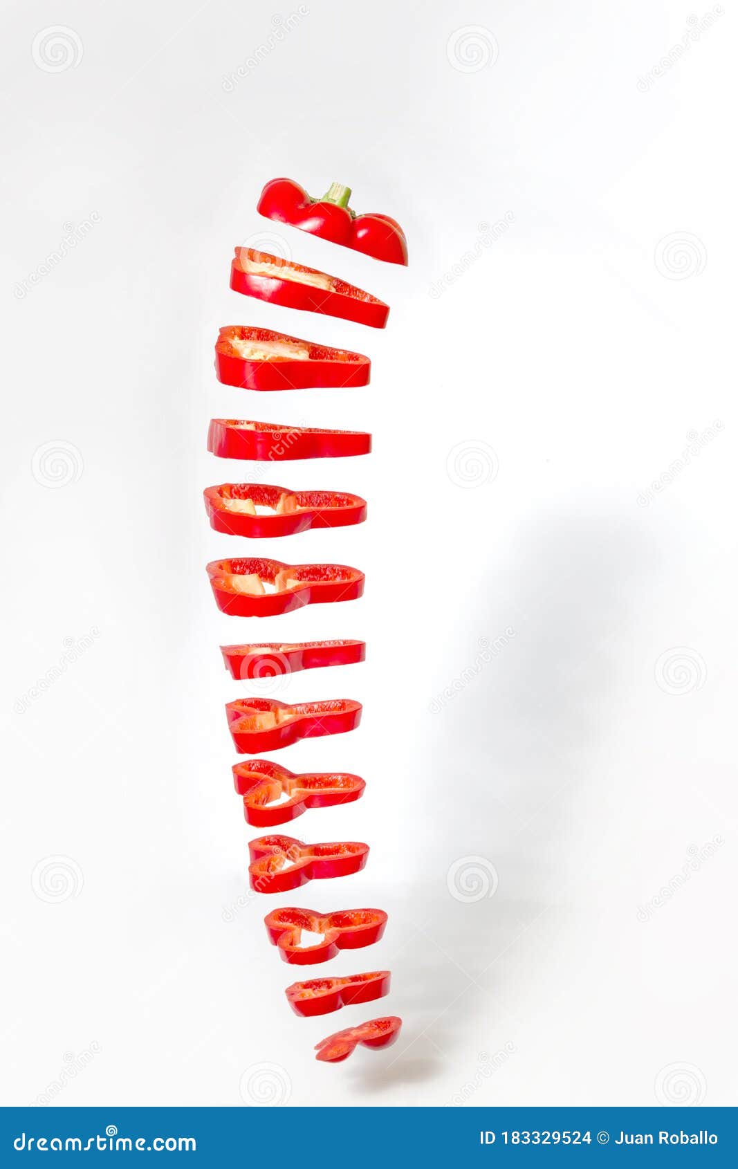 Chili Pepper Cut into Slices Floating in the Air on a White Background