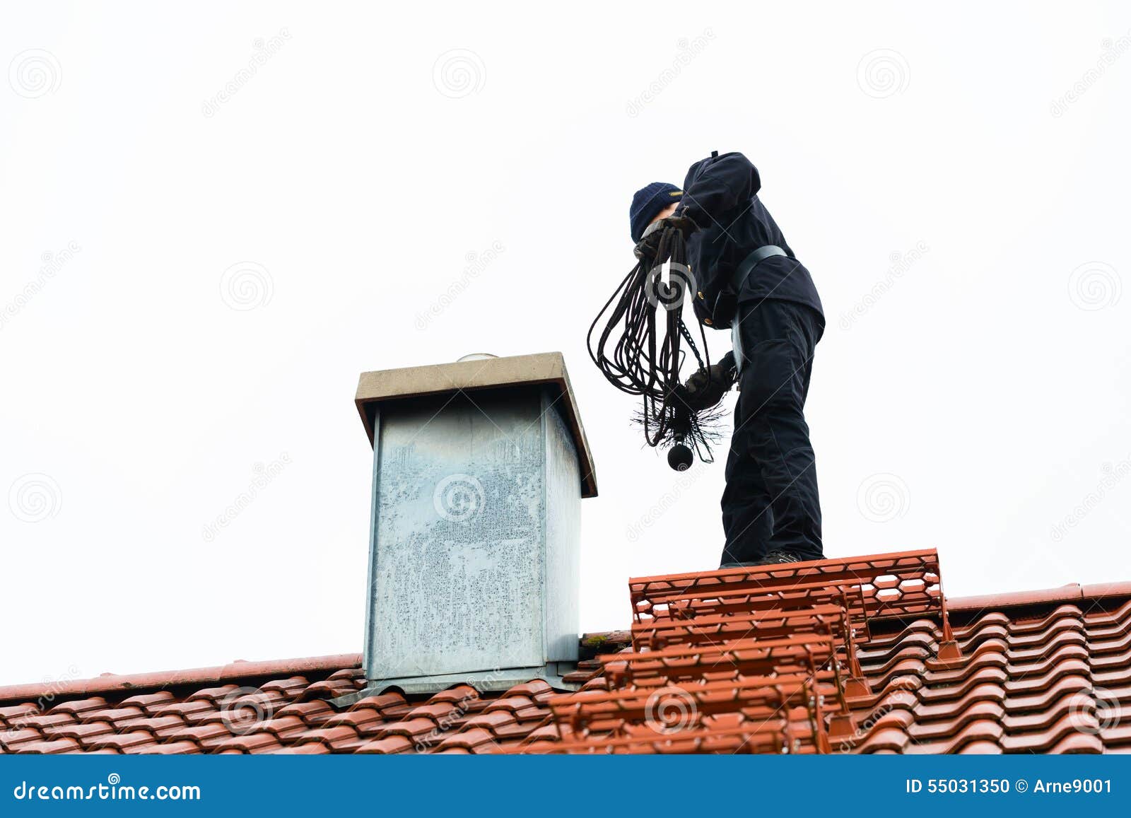 chimney sweep on roof of home working