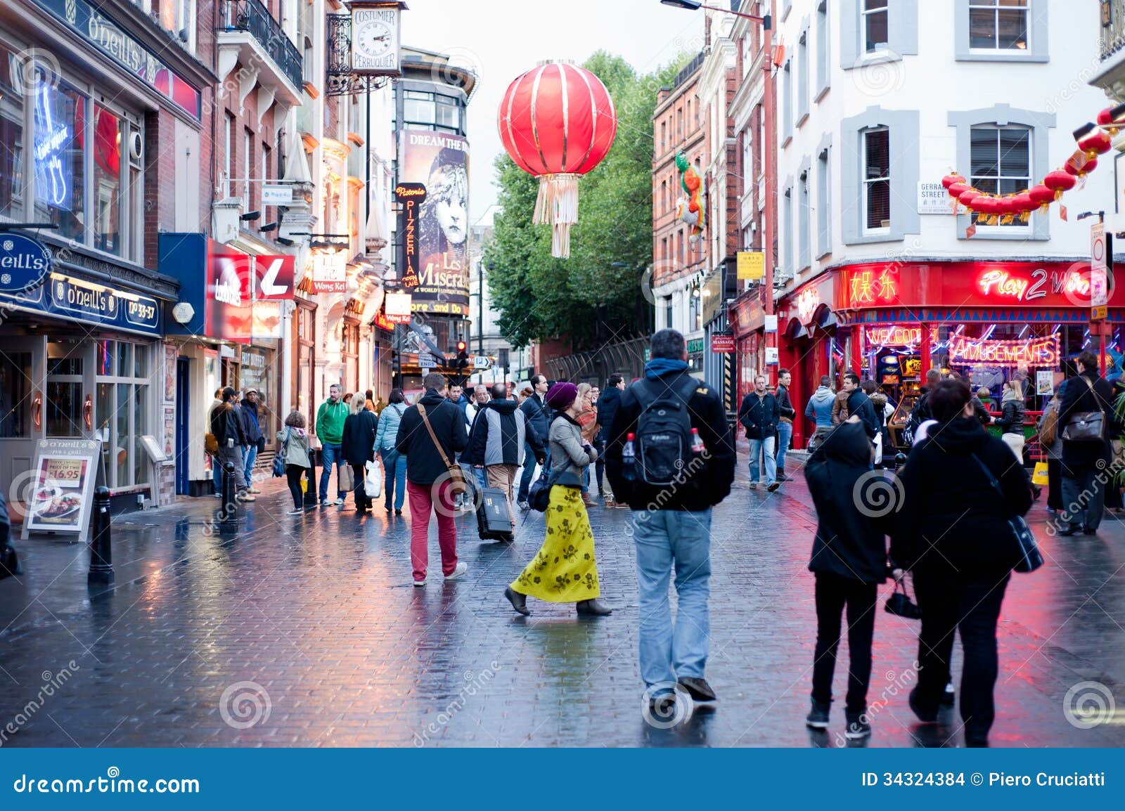 People stroll in Chinatown in London on October 10, 2013. With tens of restaurants, shops and bars, Chinatown is a popular touristic and nightlife area.