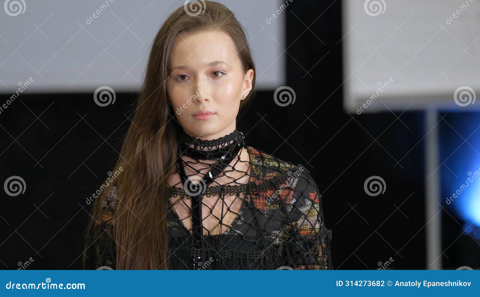 chinese asian fashion model on catwalk podium. female vogue defile on runway.