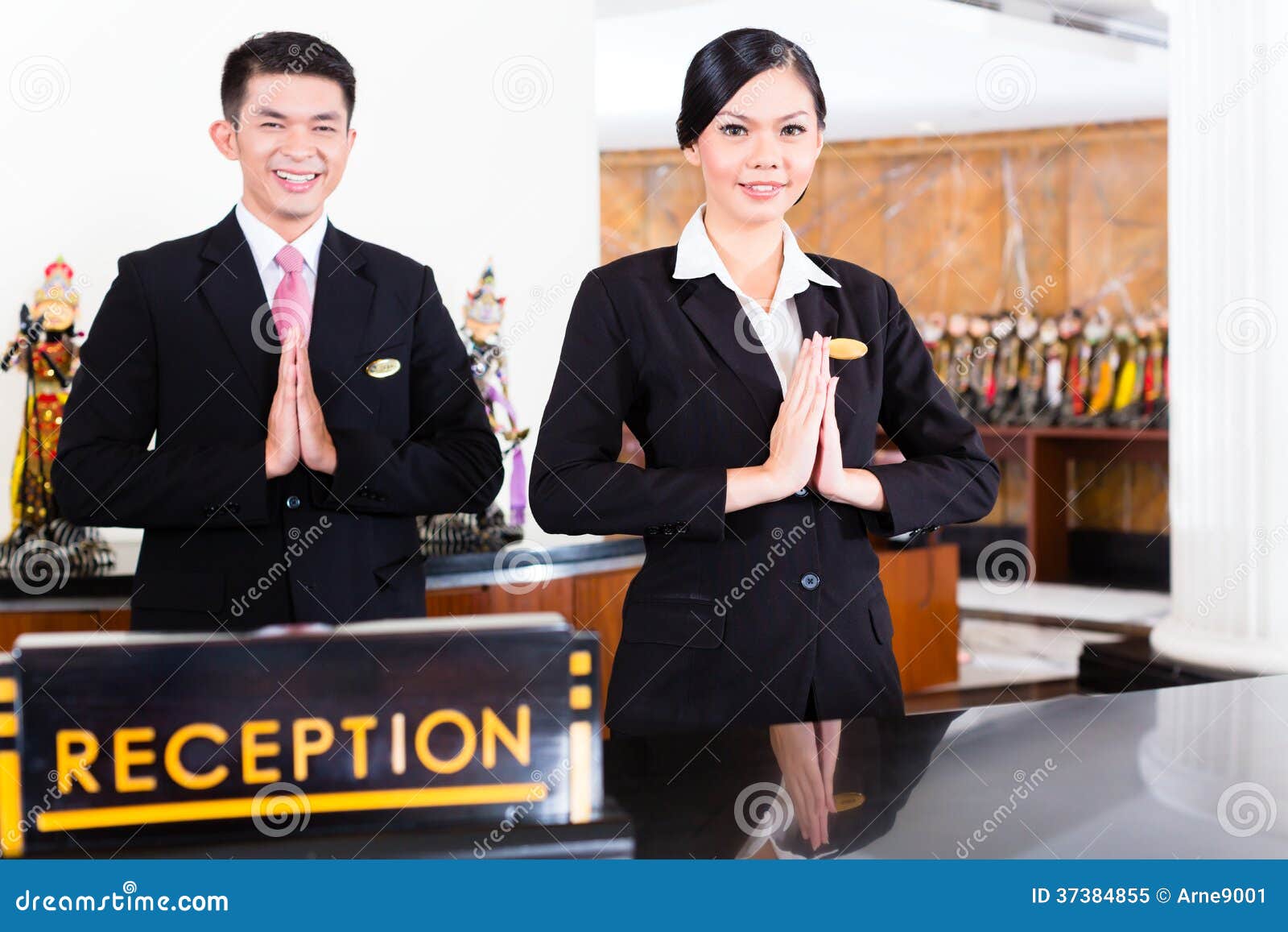 Chinese Asian Reception Team At Hotel Front Desk Stock Image