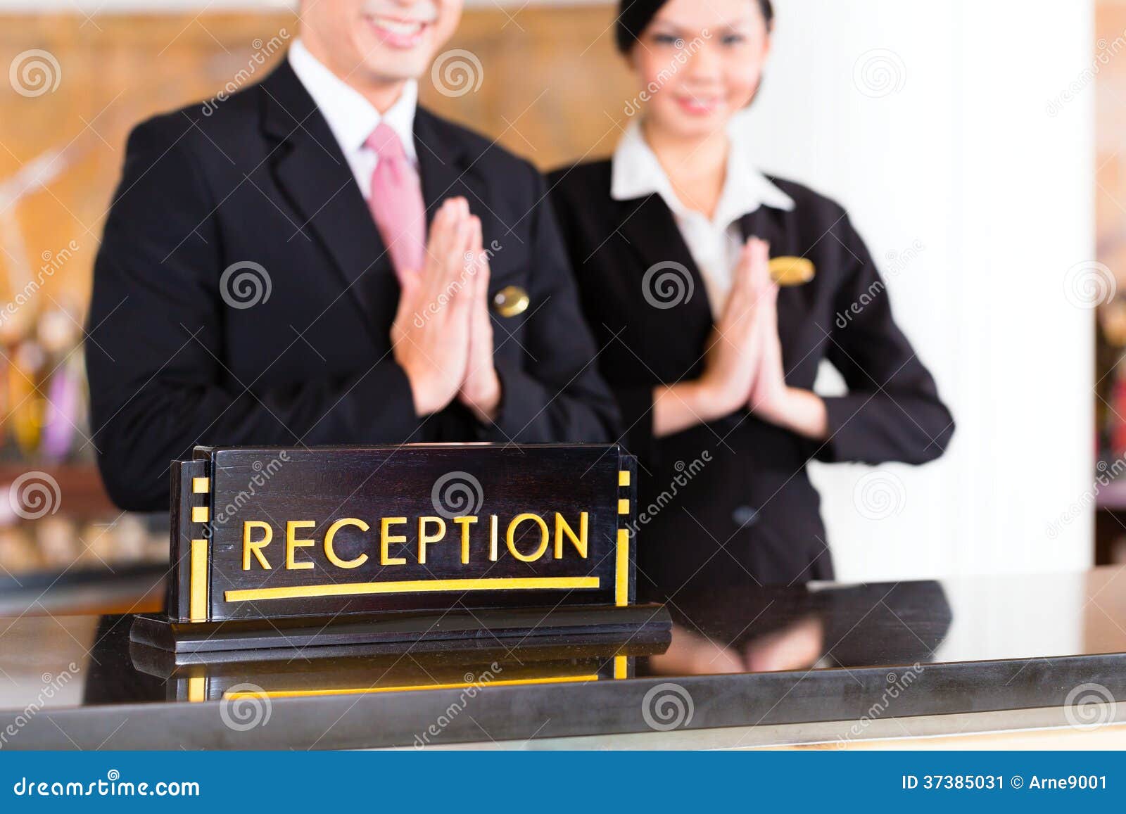 Chinese Asian Reception Team At Hotel Front Desk Stock Image