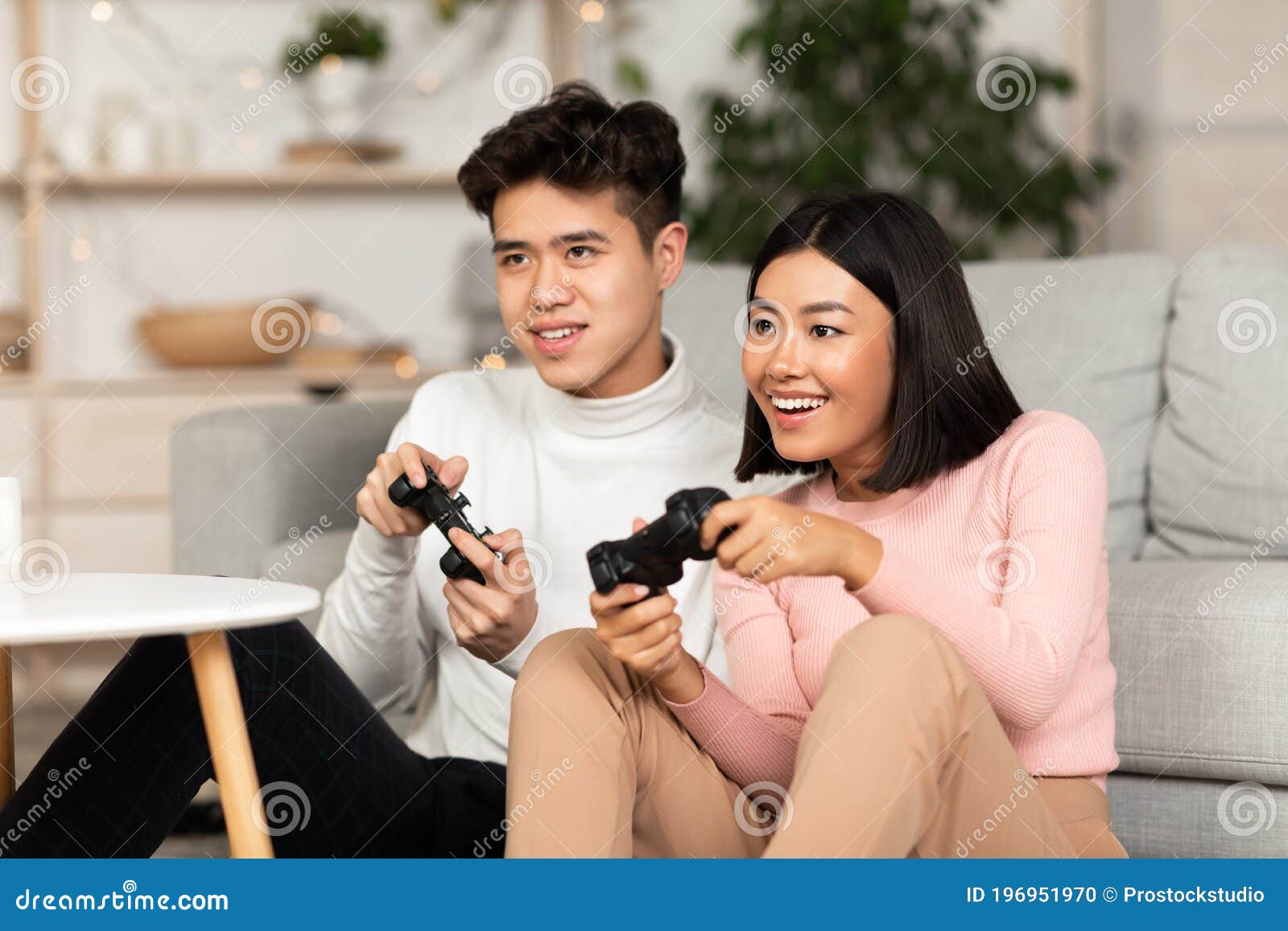 Boyfriend learning his girlfriend to play video games on