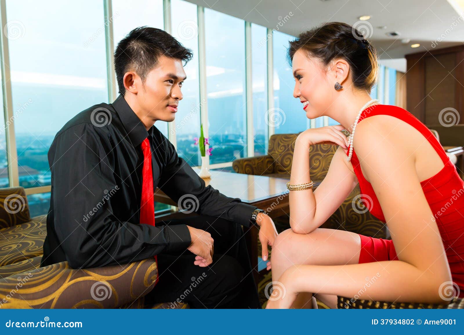 Chinese Couple Flirting in a Luxury Sky Hotel Bar Stock Photo pic