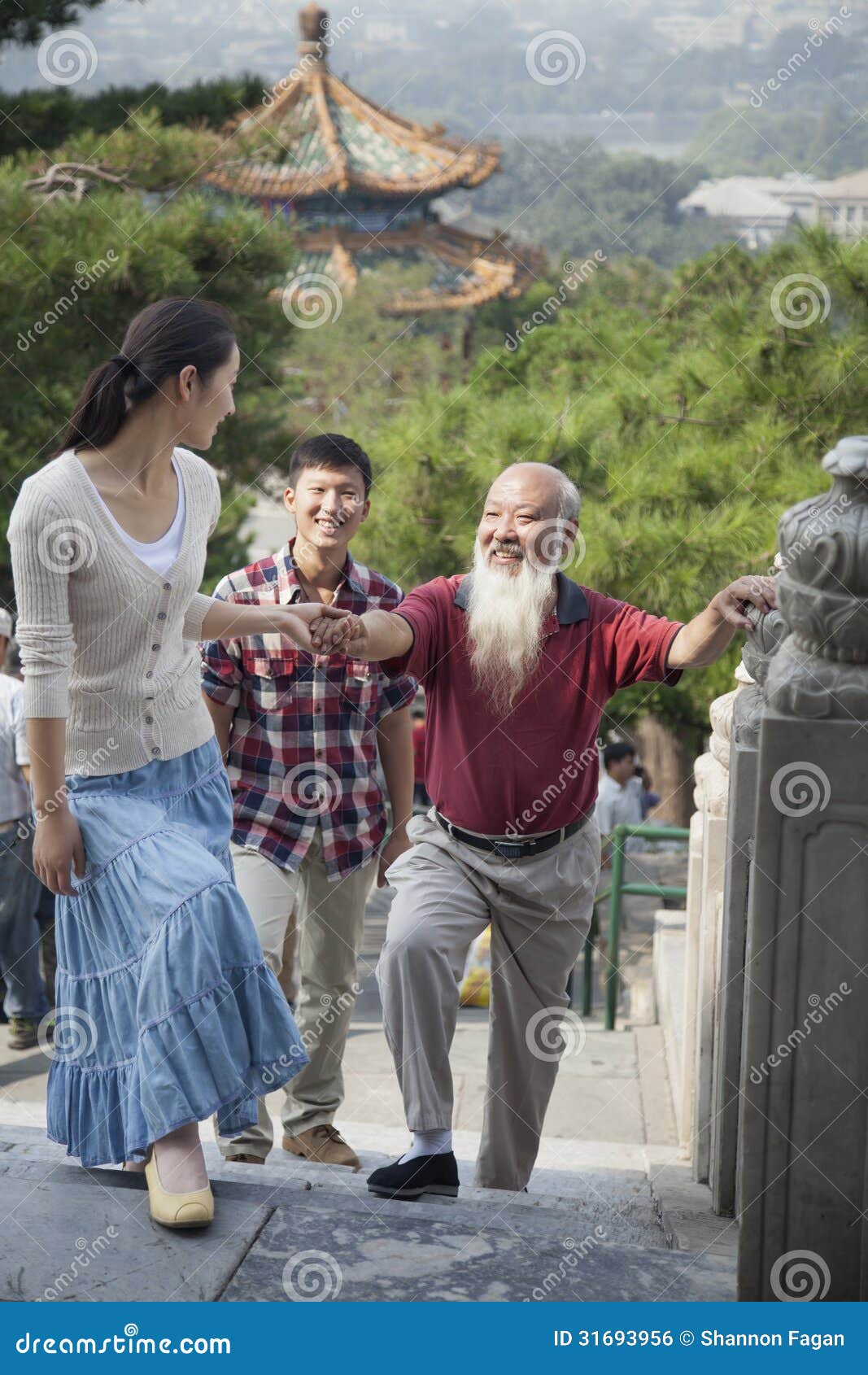 chinese family walking in jing shan park