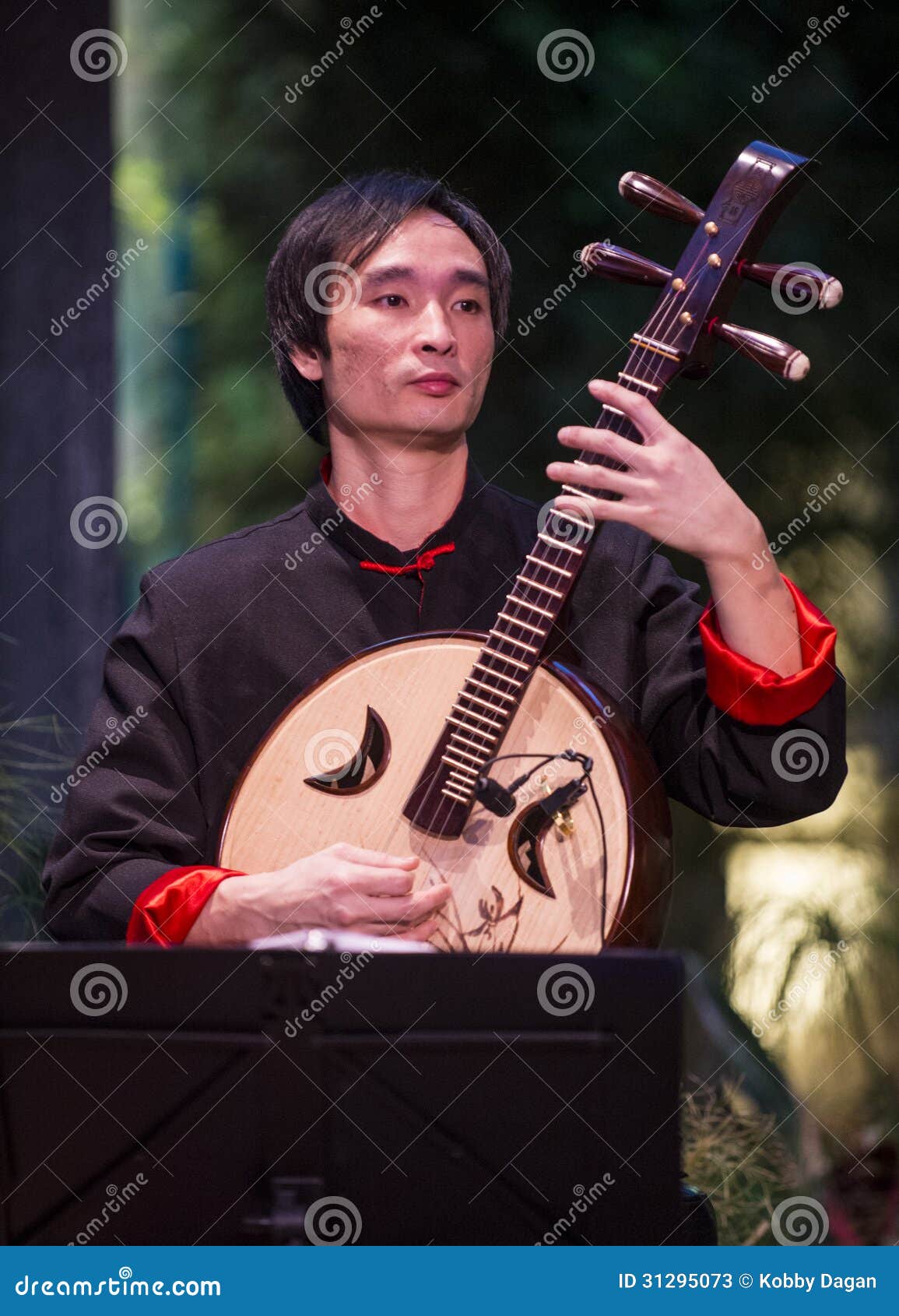 Chinese Musician Demonstrating A Traditional Chinese Musical Instrument