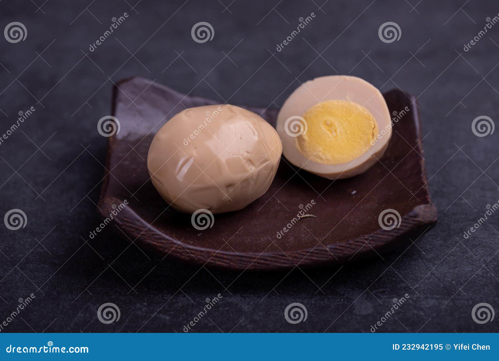 Chinese Tea Eggs, Cut or Whole Marinated Eggs in Dark Background Stock