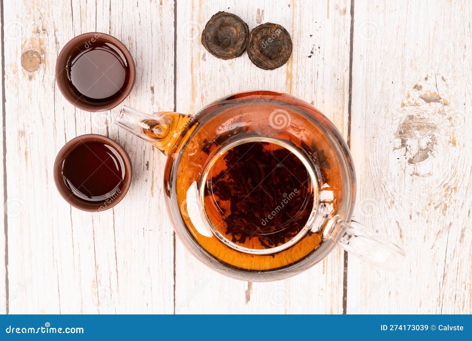 Chinese Puerh Tea in Glass Pot and Clay Cups with Puerh Tea Bricks Top