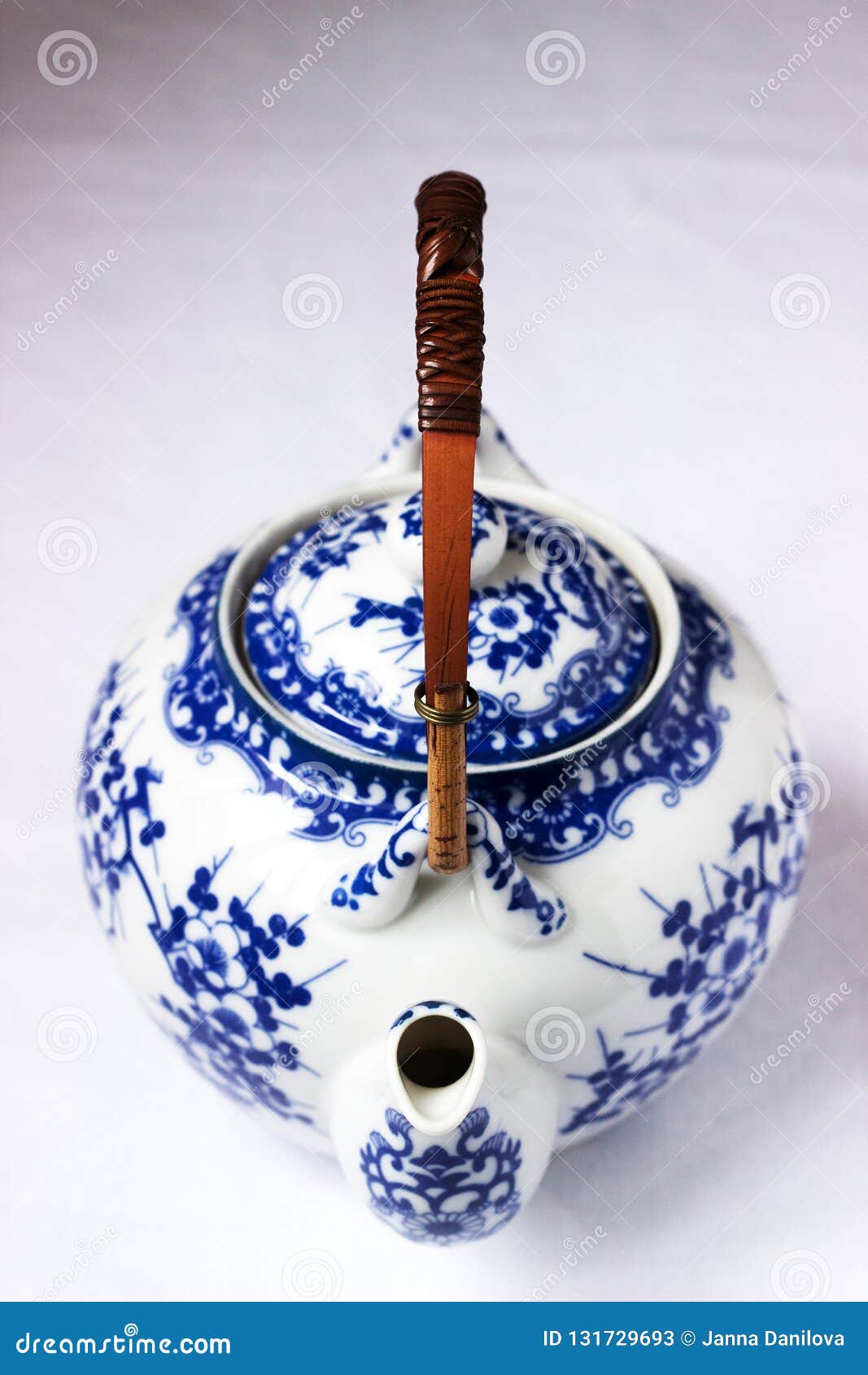 Chinese White Porcelain Teapot with Bamboo Handle and Blue Pattern on a