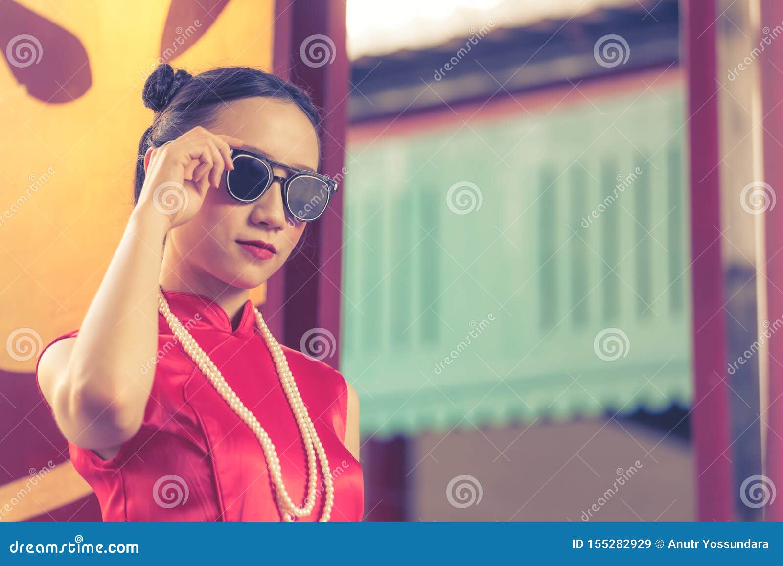 chinese woman cheongsam with sunglasses for chinese ganster concept