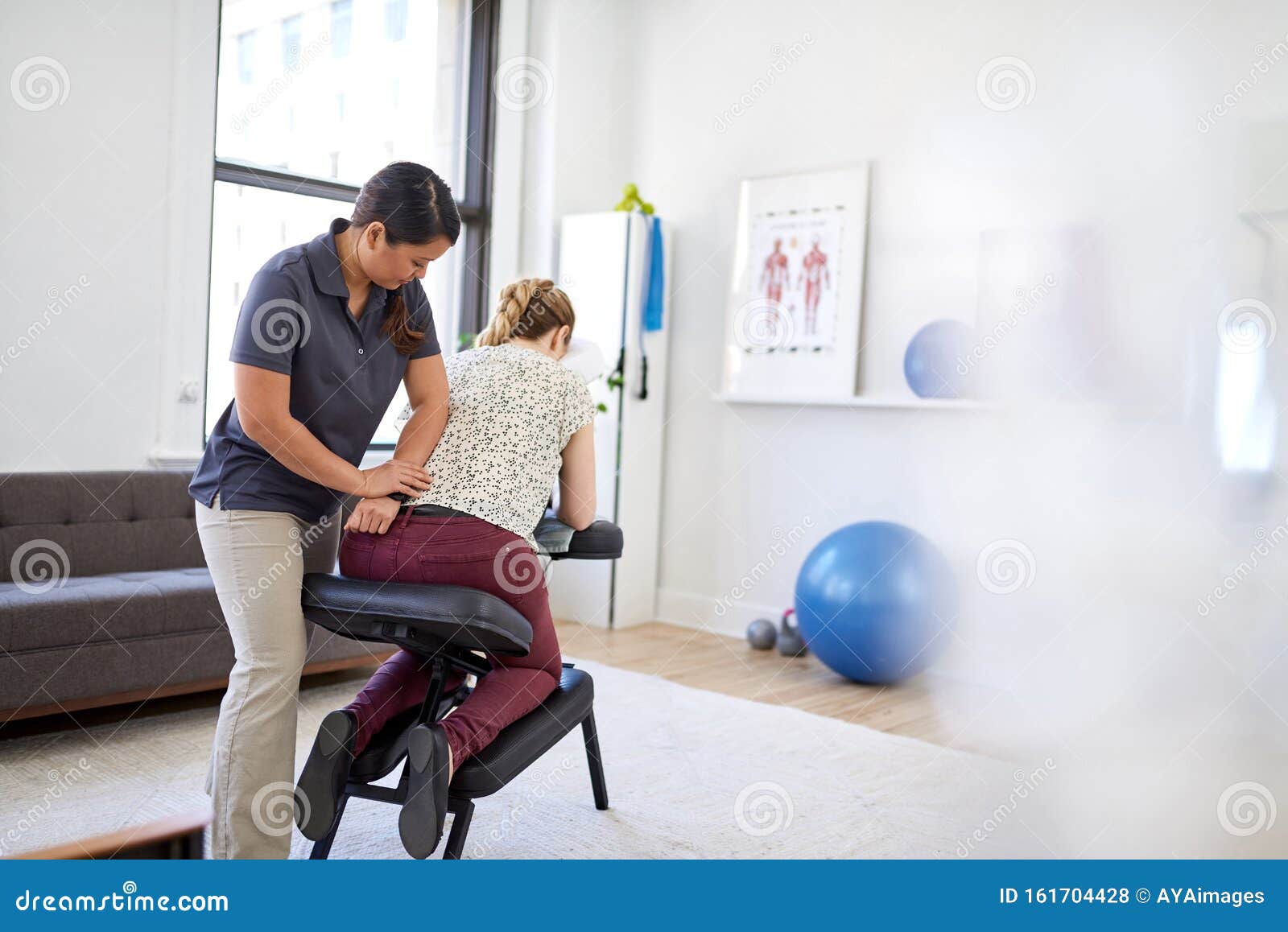Chinese Woman Massage Therapist Giving A Neck And Back Pressure Stock