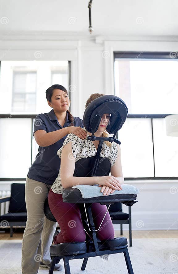 Chinese Woman Massage Therapist Giving A Neck And Back Pressure Stock