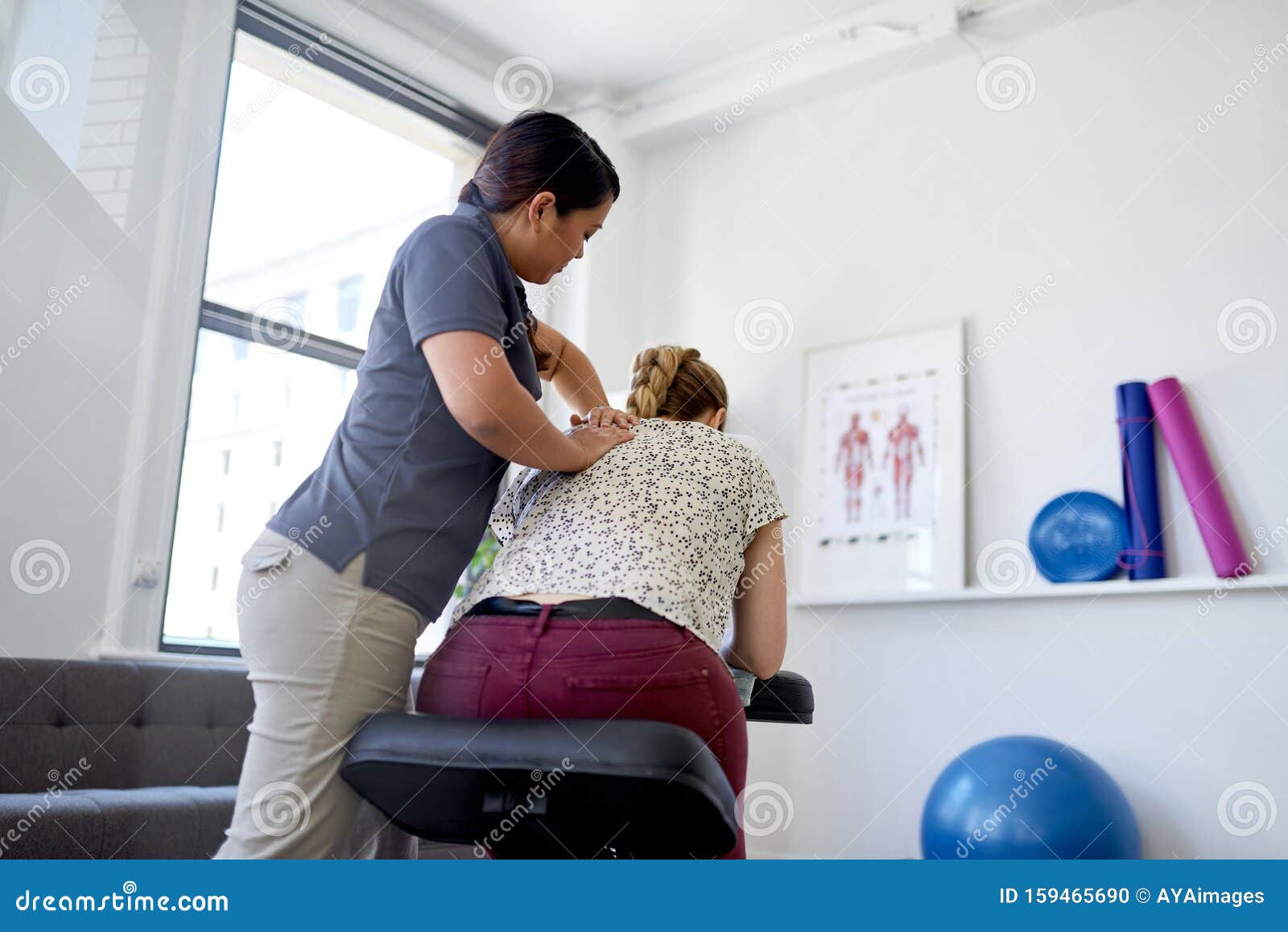 Chinese Woman Massage Therapist Giving A Neck And Back Pressure