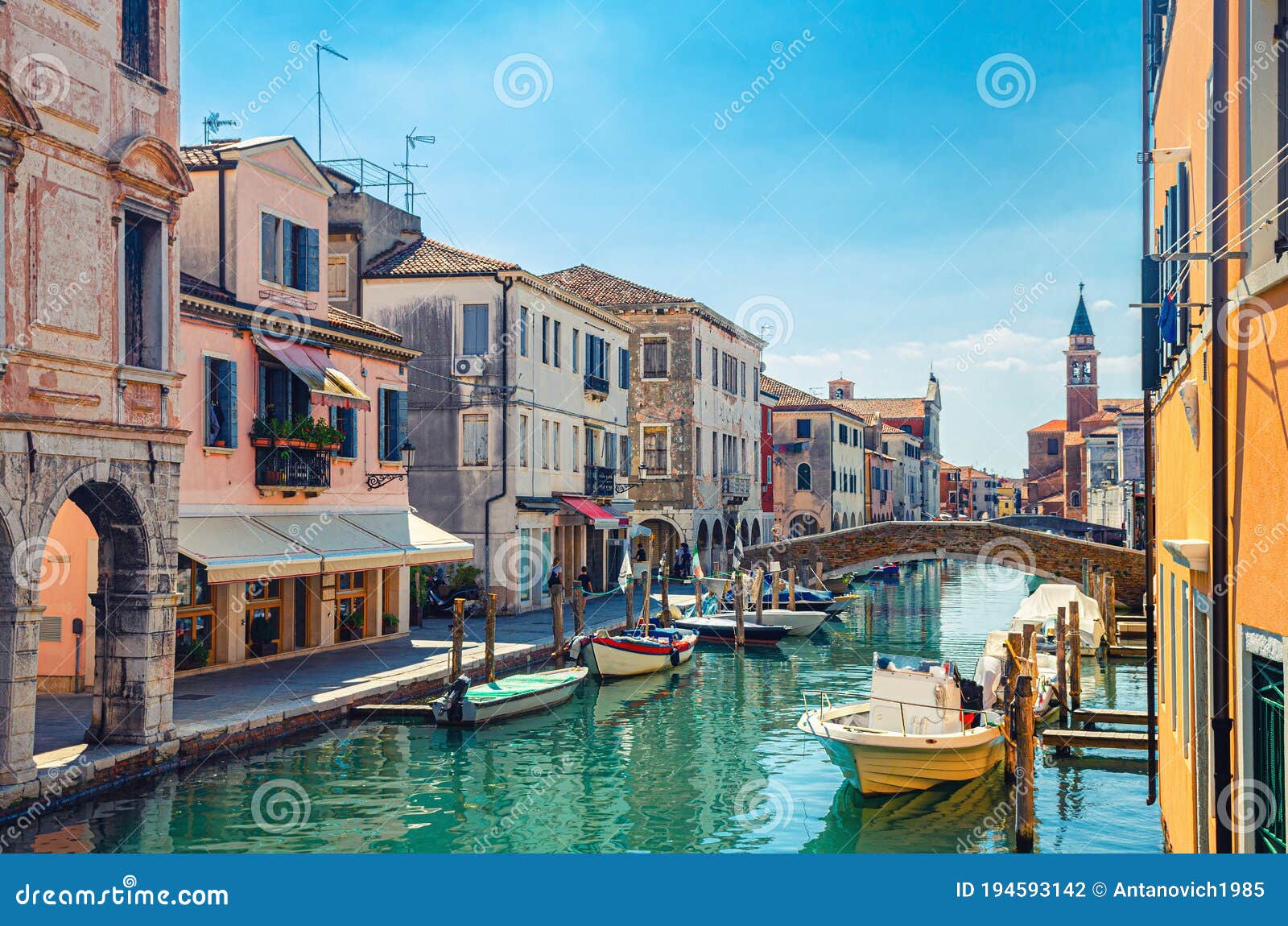 chioggia cityscape with narrow water canal vena with moored multicolored boats