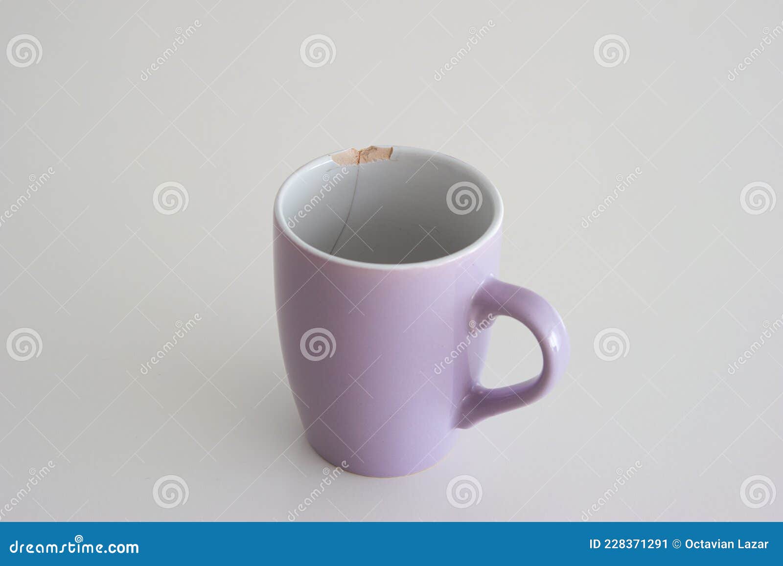 chipped coffee mug on white background, shallow depth of field