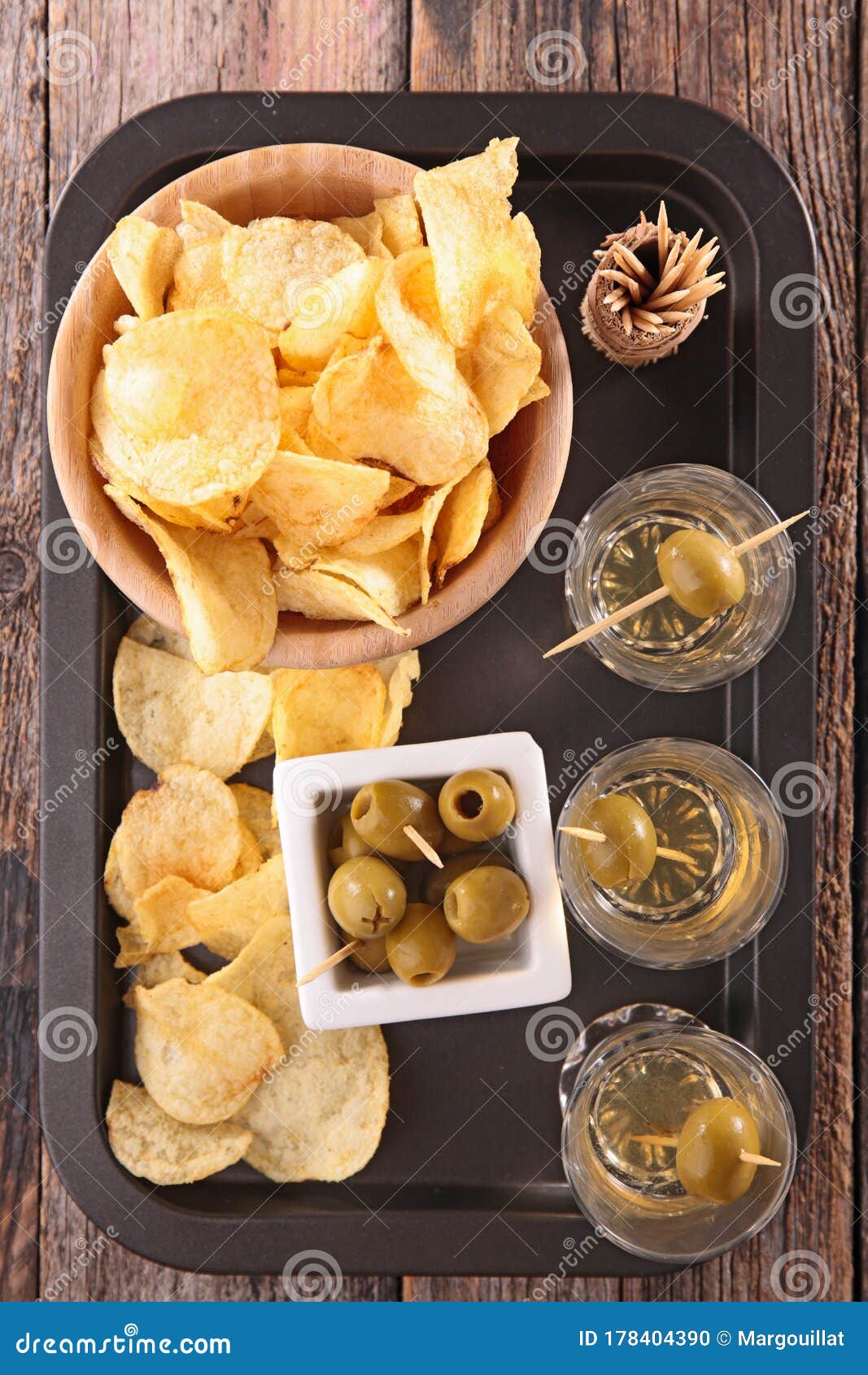Chips, alcohol and olive stock photo. Image of glass 178404390