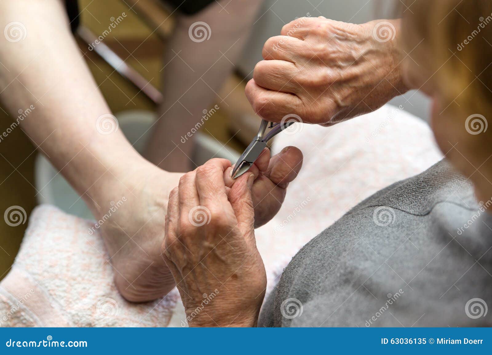 chiropodist with a nail scissors