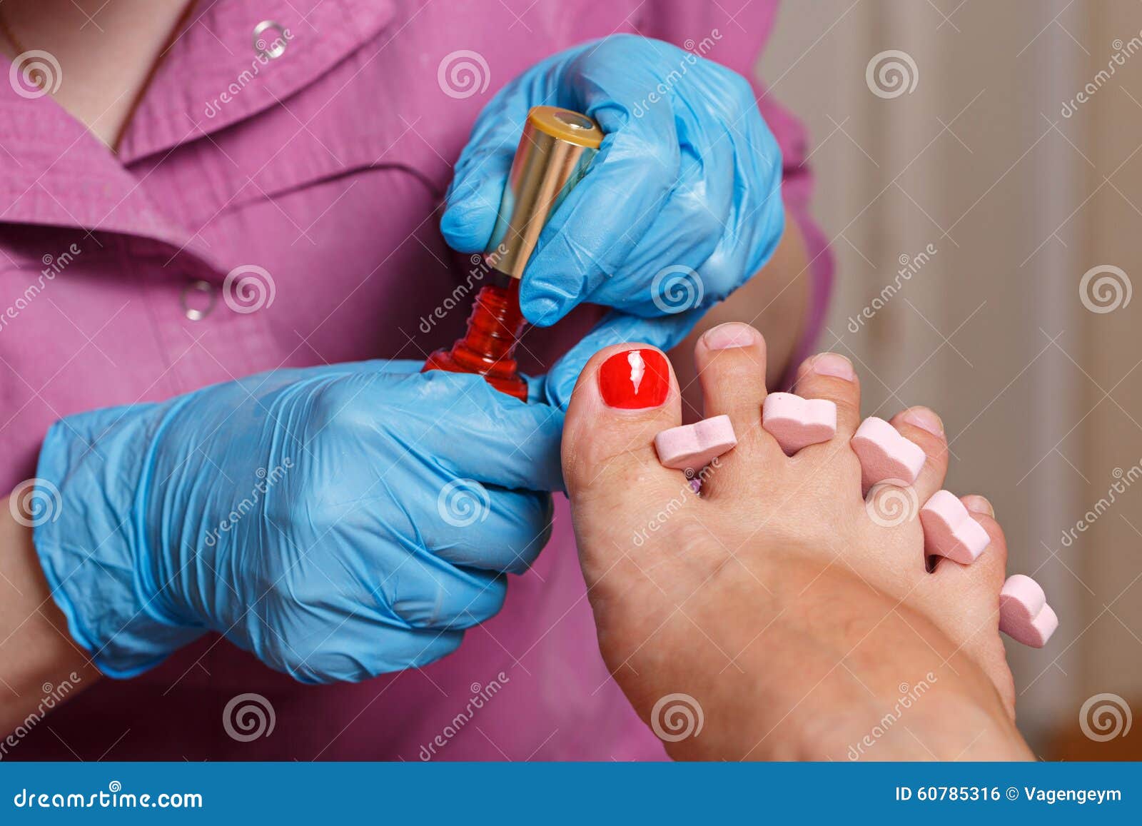 chiropody spa salon. applying gel nail polish.