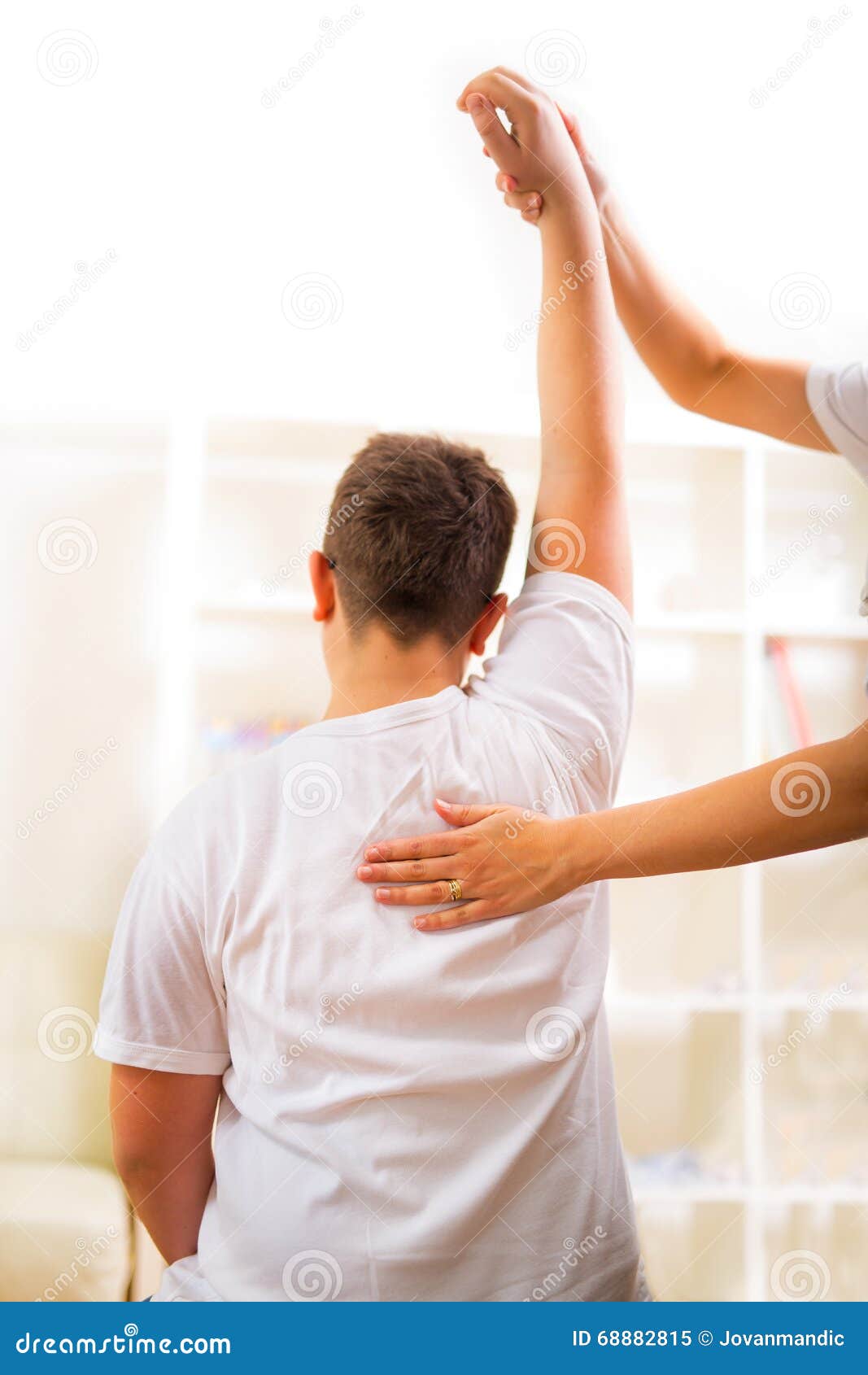 Chiropractor Doing Adjustment on Male Patient. Selective Focus Stock
