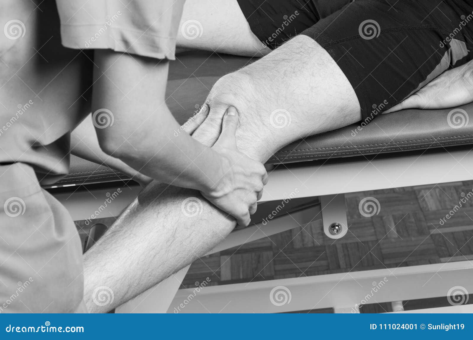 Chiropractor /physiotherapist Doing a Knee Massage. Stock Image Image