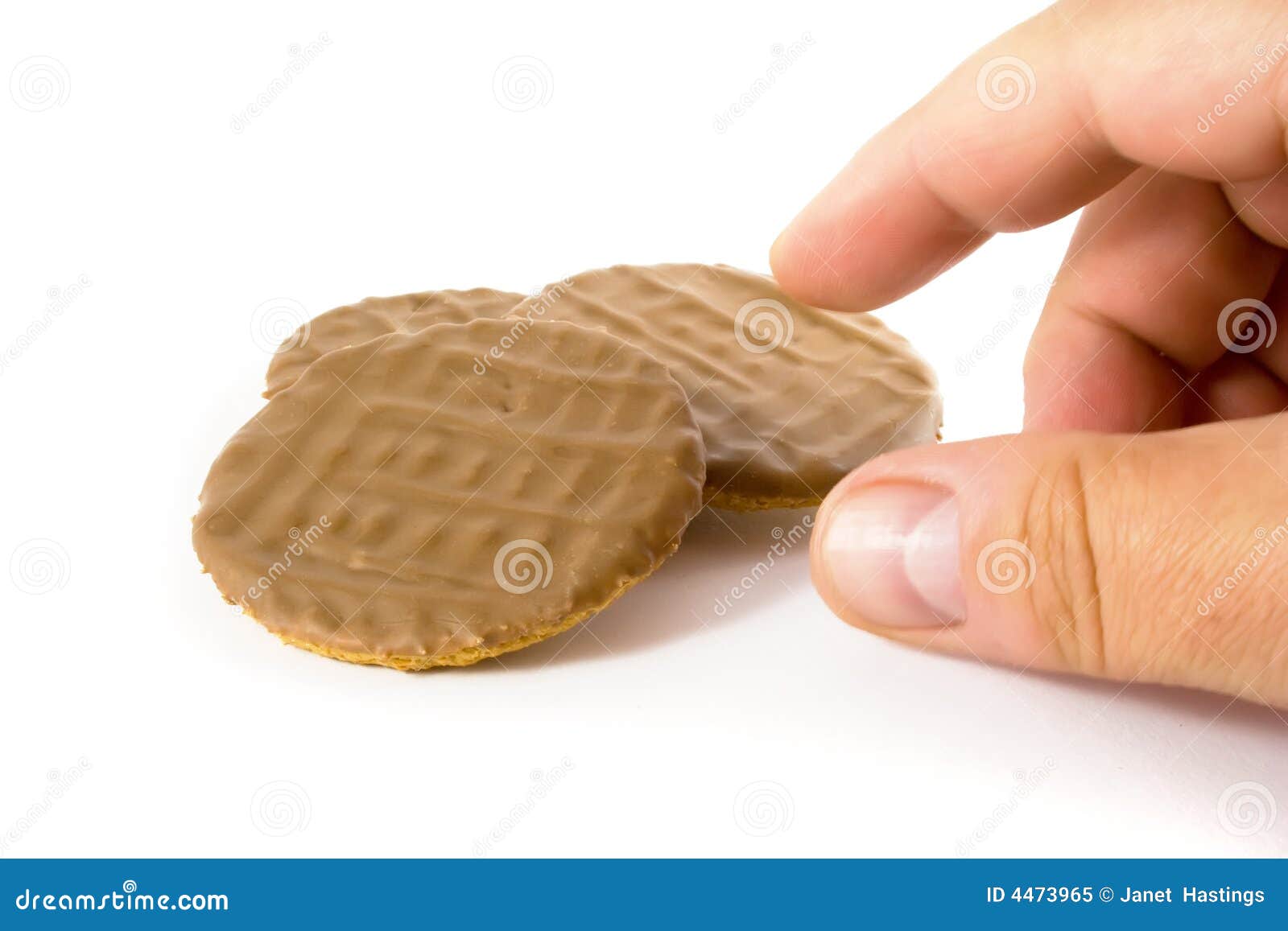 Chocolate Biscuit Temptation. Hand reaching for a delicious chocolate biscuit over white