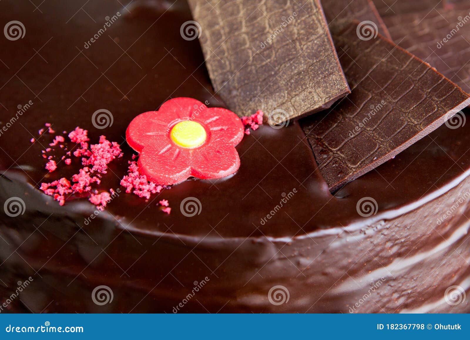 chocolate cake with chocolate ornaments and red marzipan rose