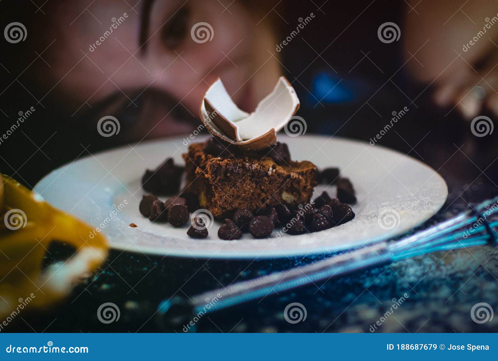 chocolate cake close up with girl at the back