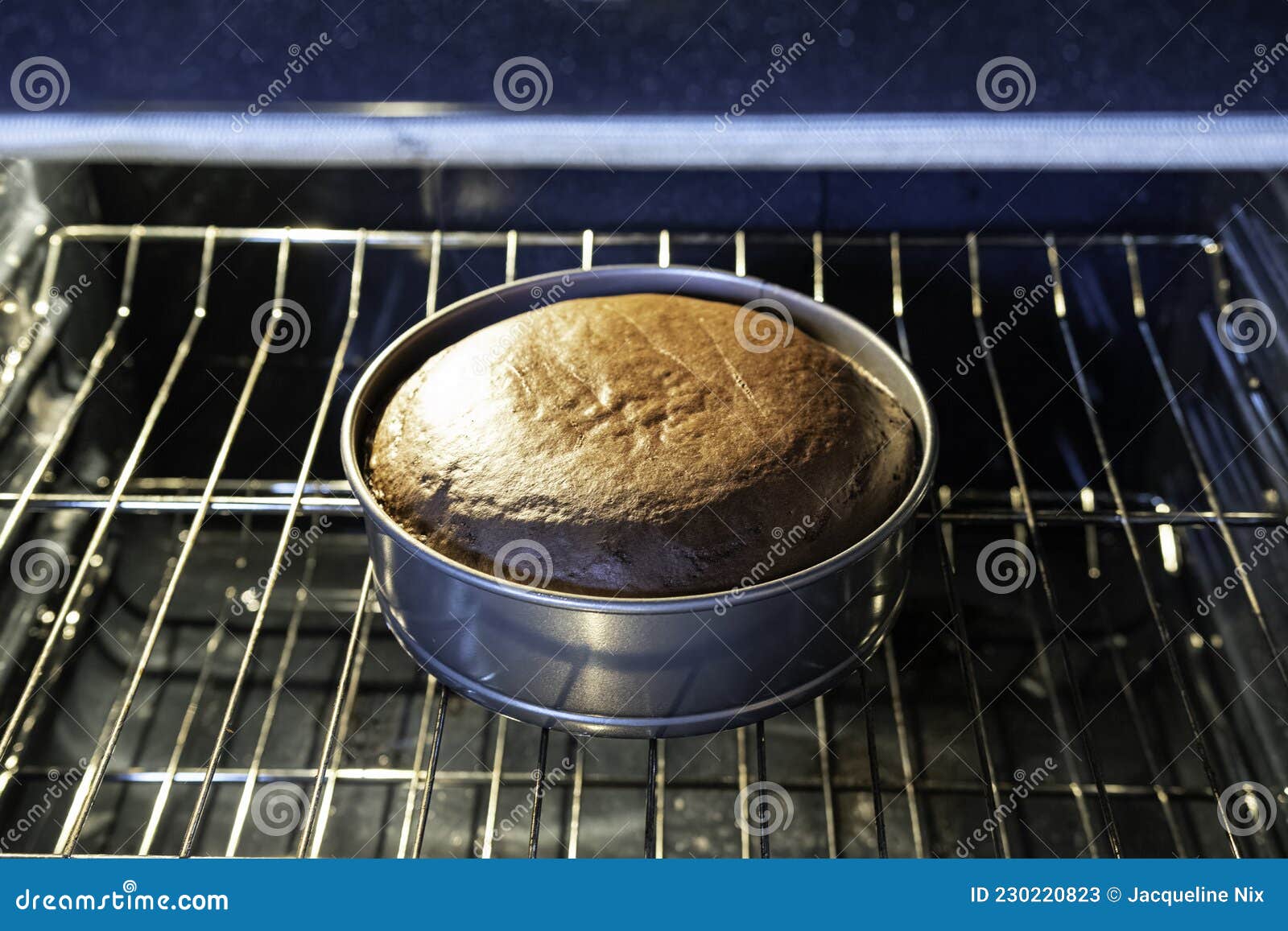 Chocolate cake in oven stock image. Image of appliance 230220823