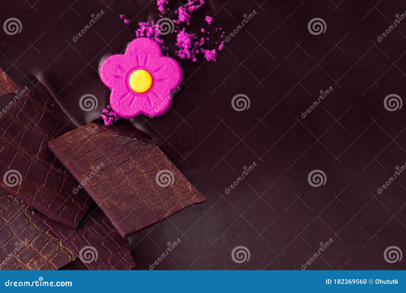 chocolate cake with white chocolate ornaments and violet marzipan rose flower