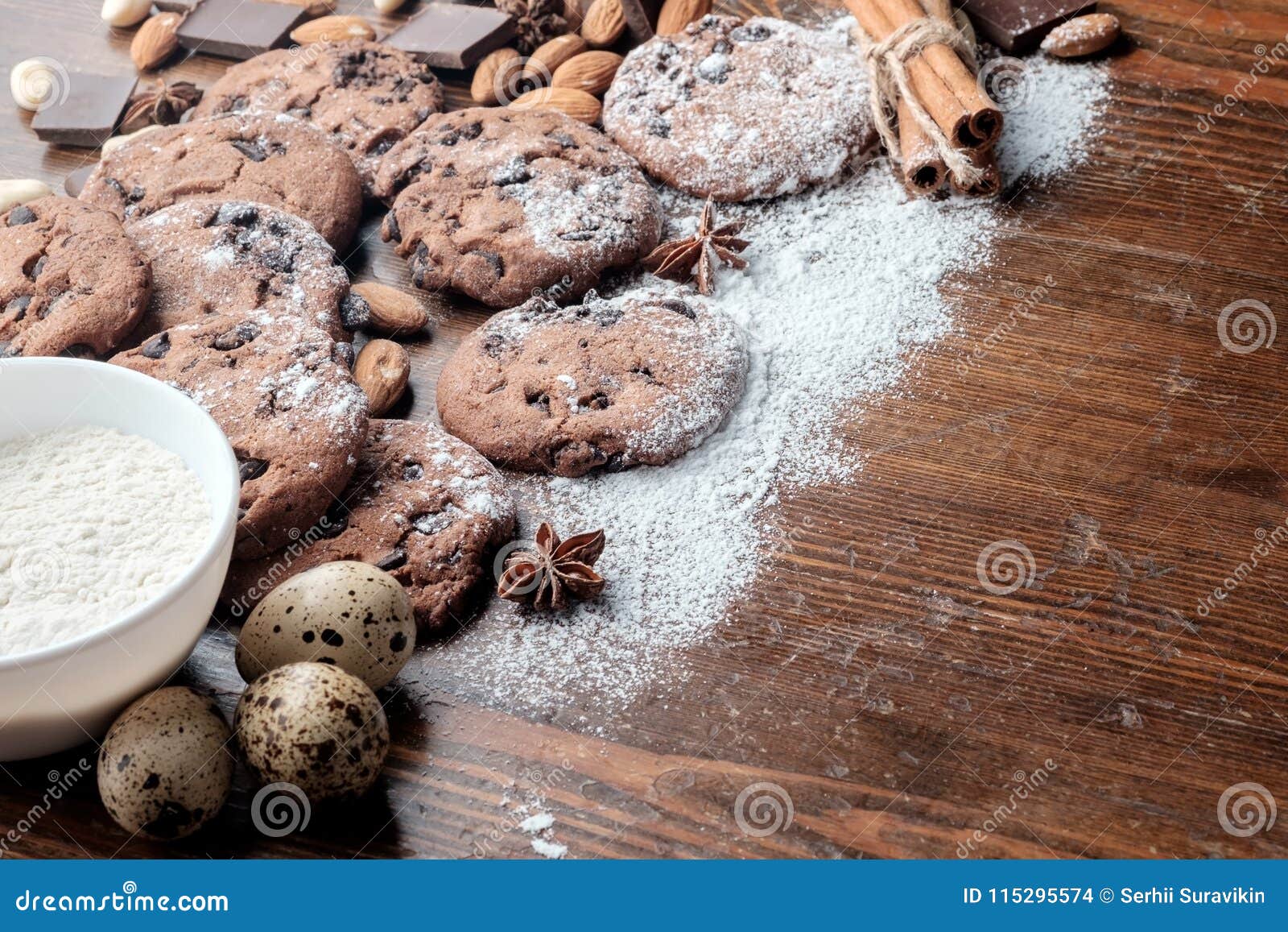 chocolate chips cookies and scattered peanuts, almonds and pieses of chocolate