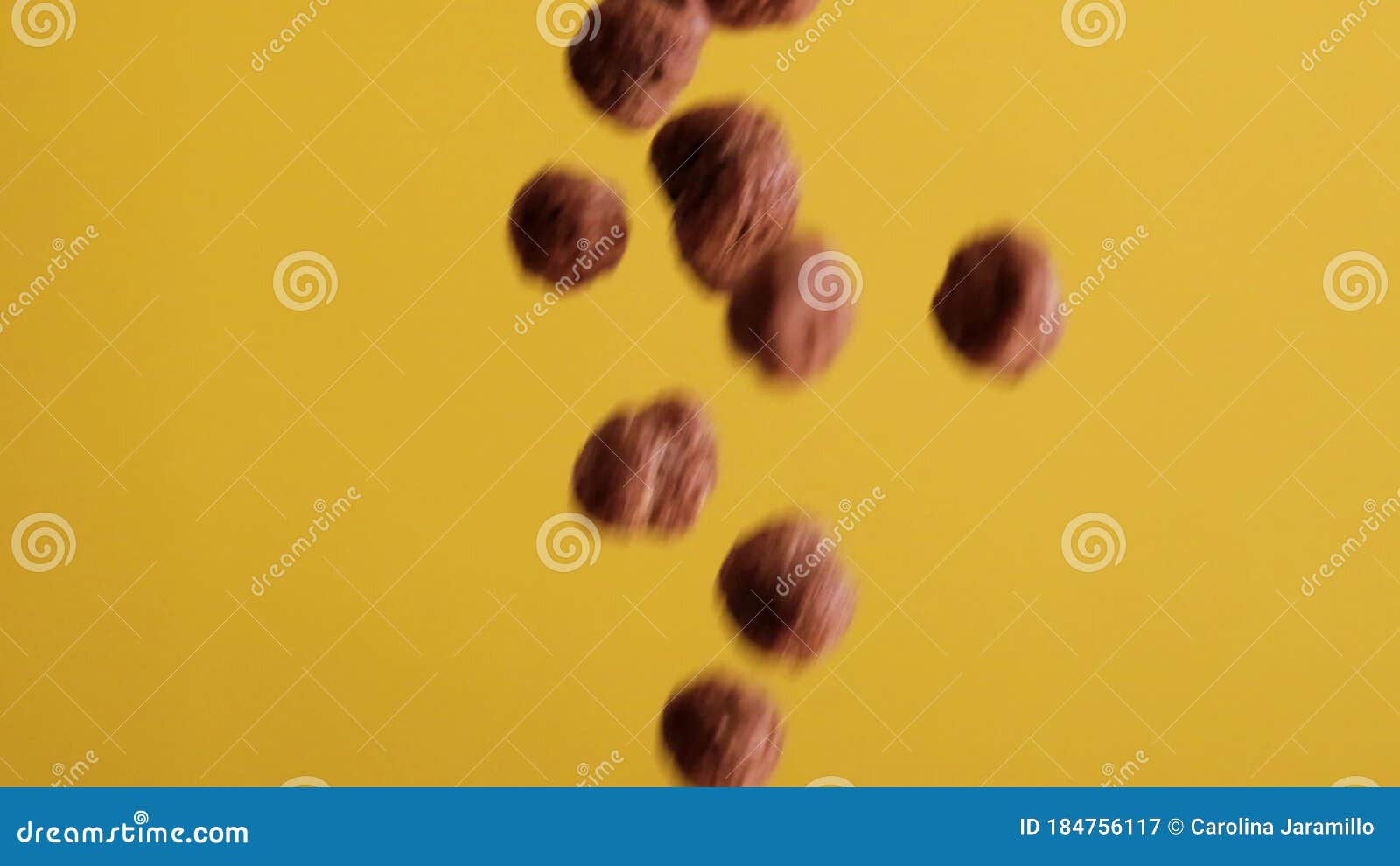 Chocolate Corn Cereal Balls Moving Up and Down on a Yellow Background Stock Video Video of