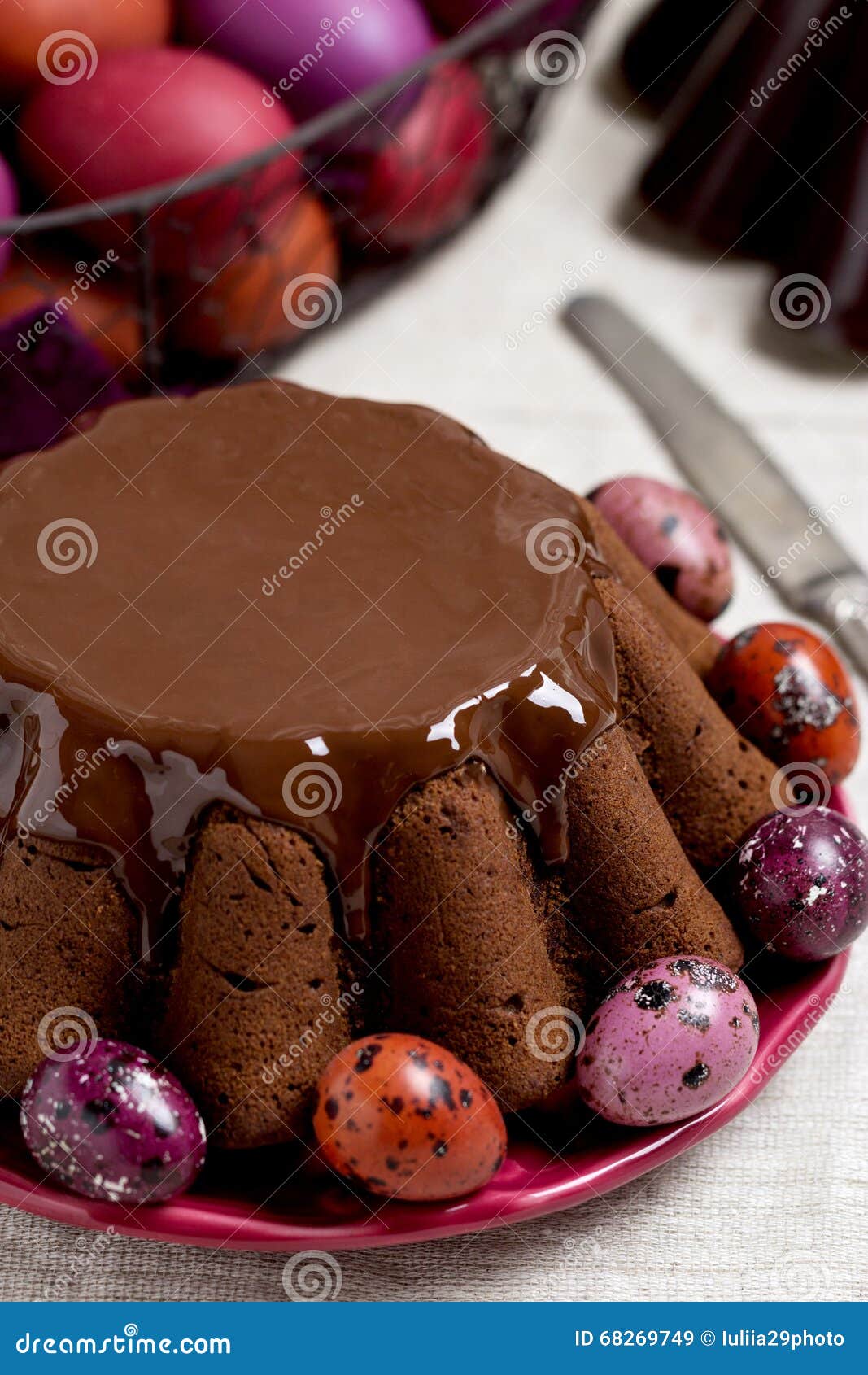 Chocolate Easter Cake and Easter Eggs Colored in Purple and Brow Stock