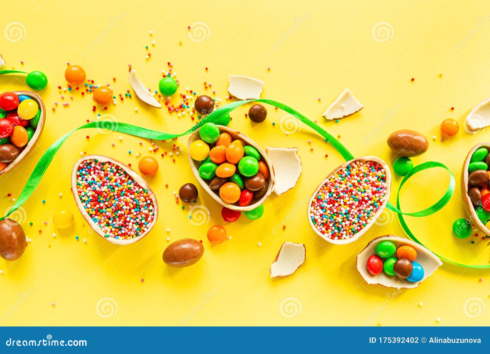 Download Chocolate Easter Eggs And Colorful Candies On Yellow Paper Background. Flat Lay, Top View ...
