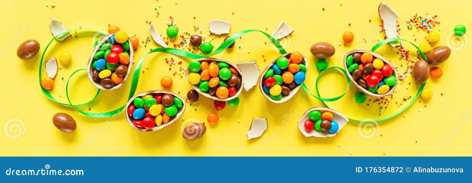 Download Chocolate Easter Eggs And Colorful Candies On Yellow Paper Background. Flat Lay, Top View ...