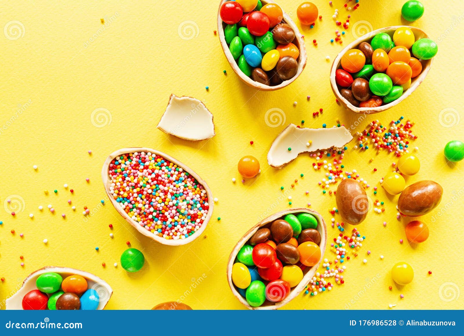 Download Chocolate Easter Eggs And Colorful Candies On Yellow Paper Background. Flat Lay, Top View ...