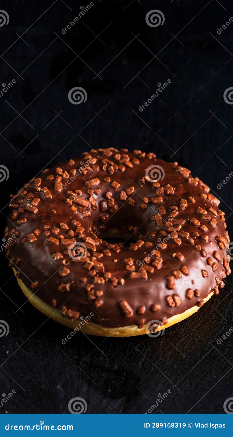 Chocolate Glazed Donut with Chocolate Chips Isolated. Close Up of