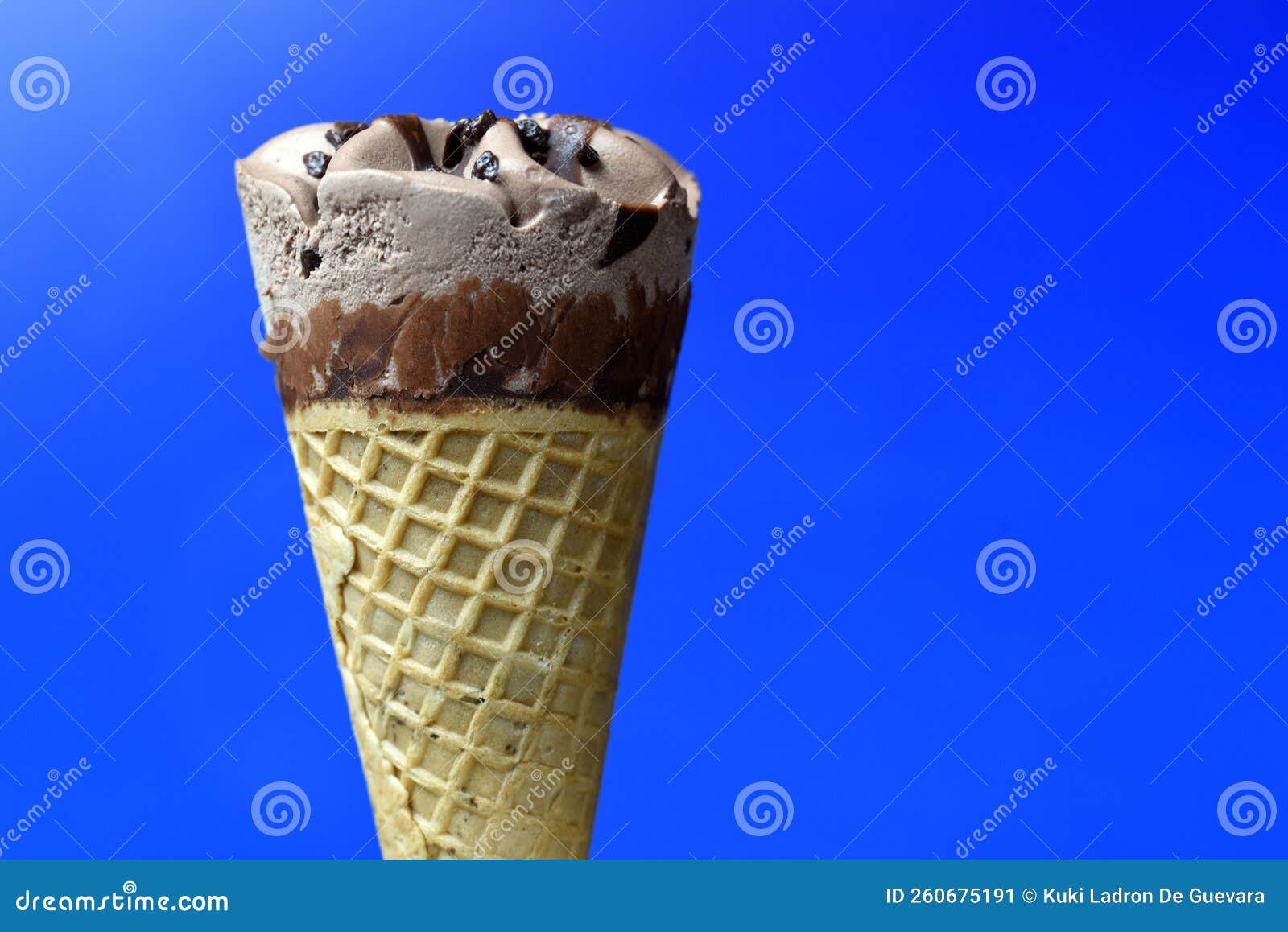 chocolate ice cream cone on blue background