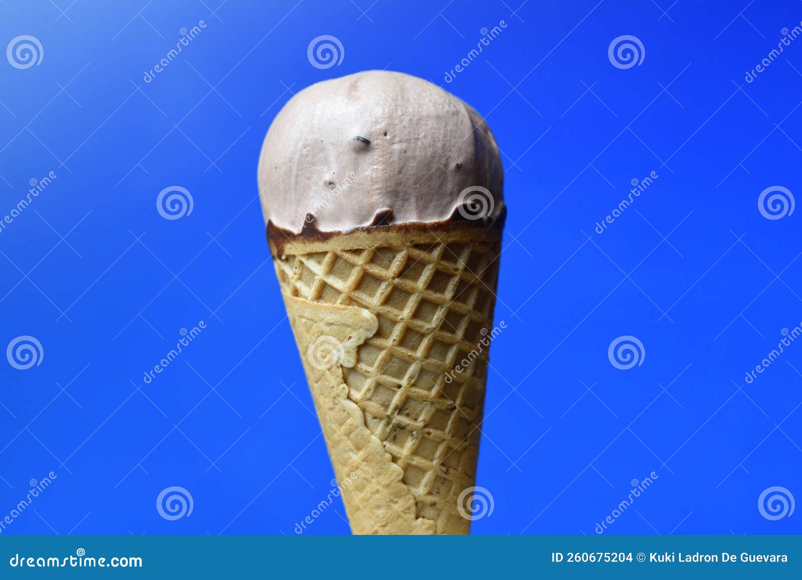chocolate ice cream cone on blue background
