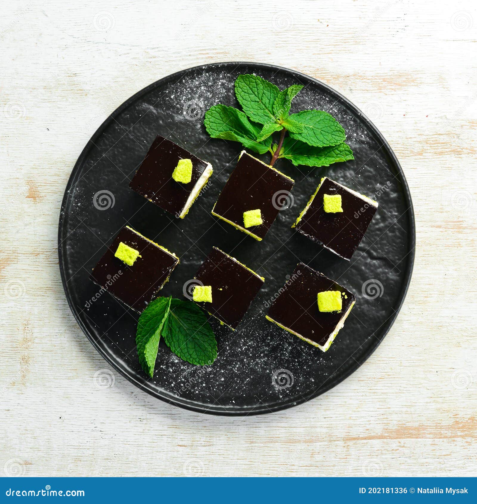 Chocolate Mousse Dessert Opera on a Black Plate with Mint. Top View