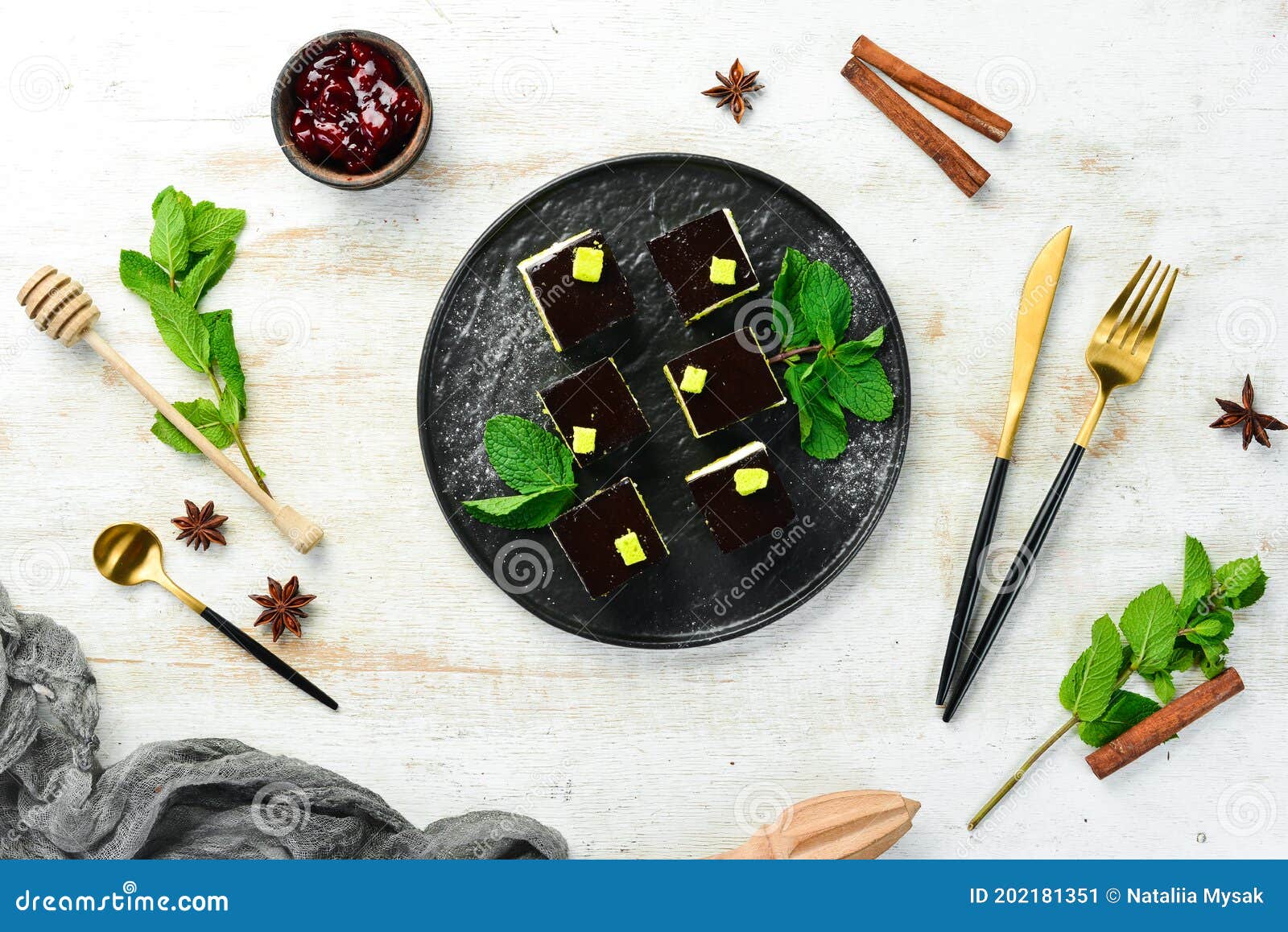 Chocolate Mousse Dessert Opera on a Black Plate with Mint. Top View