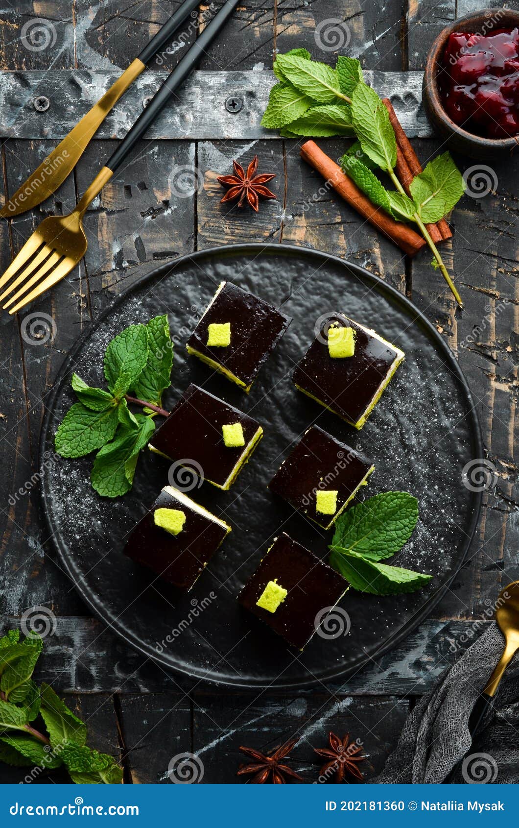 Chocolate Mousse Dessert Opera on a Black Plate with Mint. Top View
